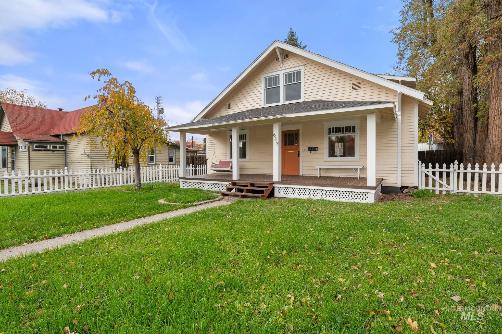 View of front of home featuring covered porch and a shingled roof