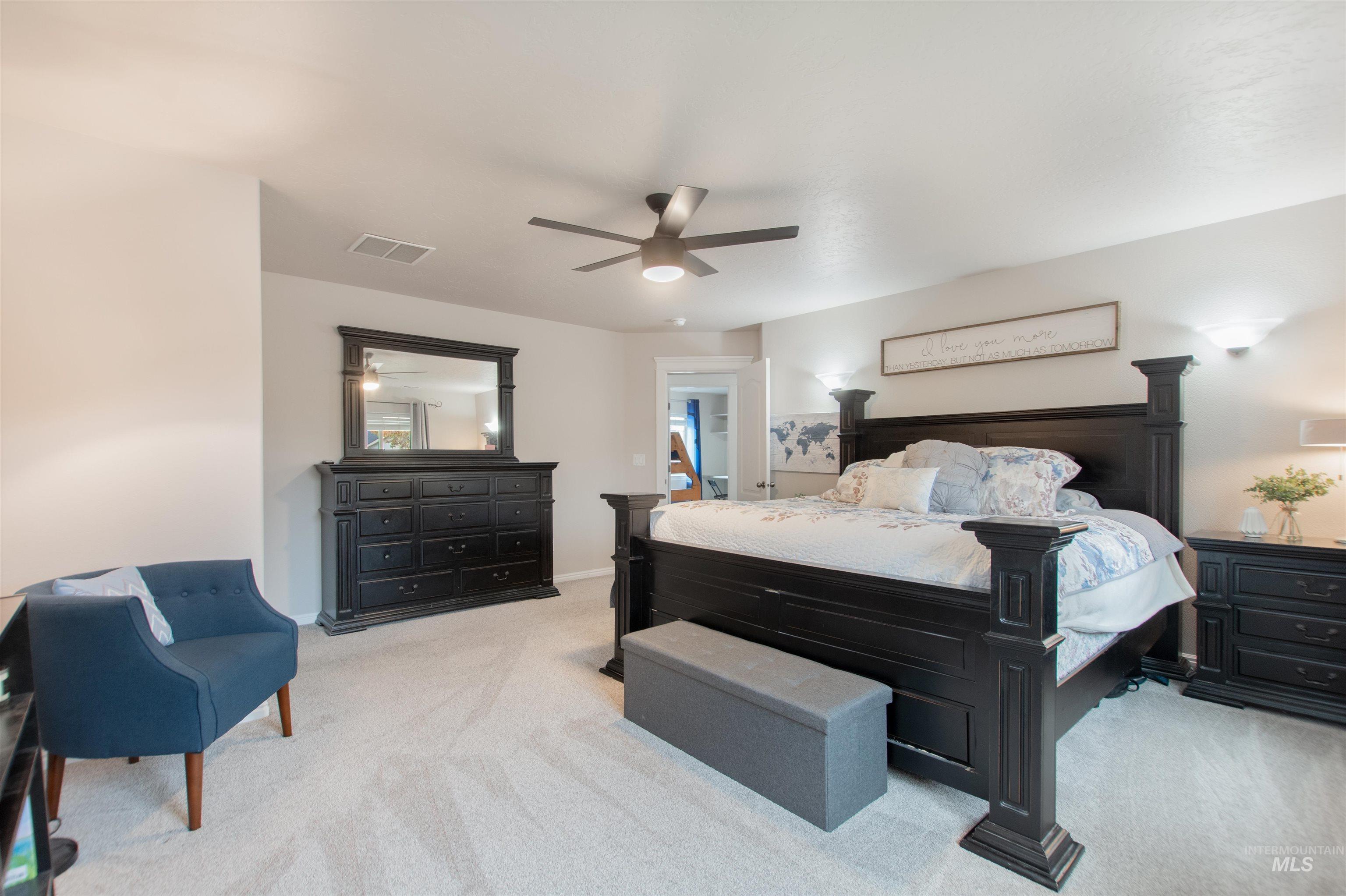 Bedroom featuring light colored carpet and ceiling fan