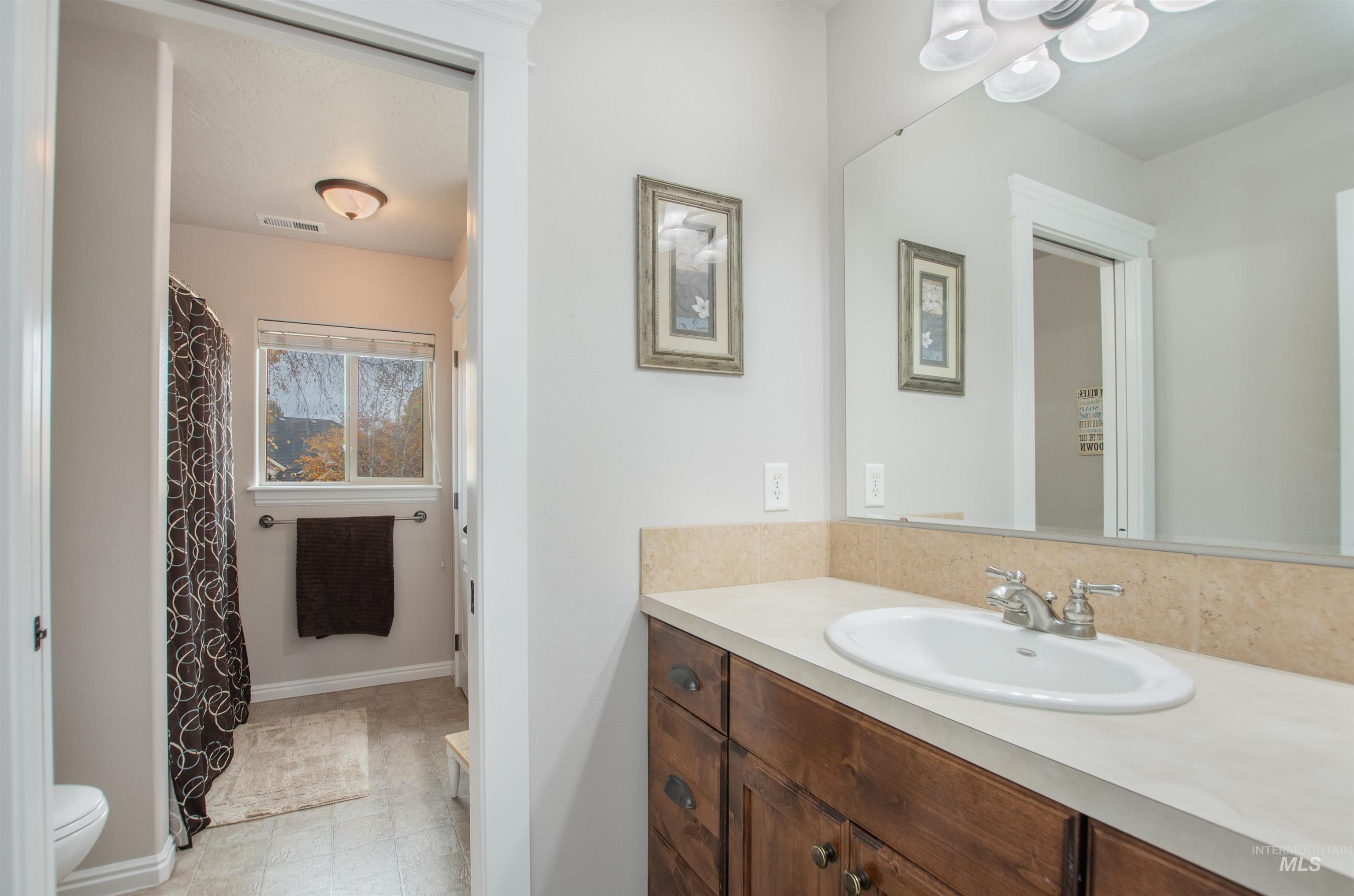 Bathroom featuring vanity and a shower with curtain