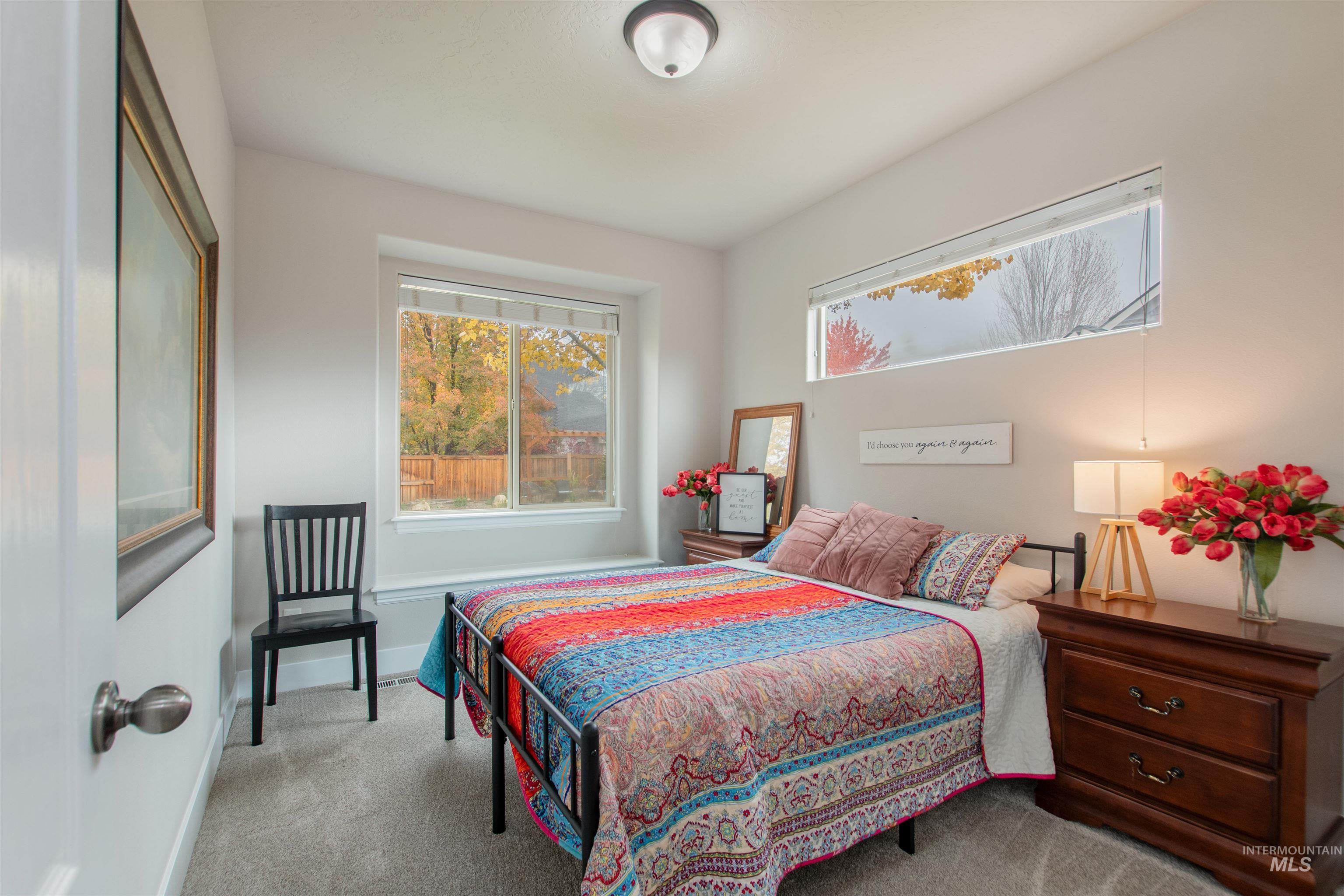 Bedroom featuring carpet and baseboards