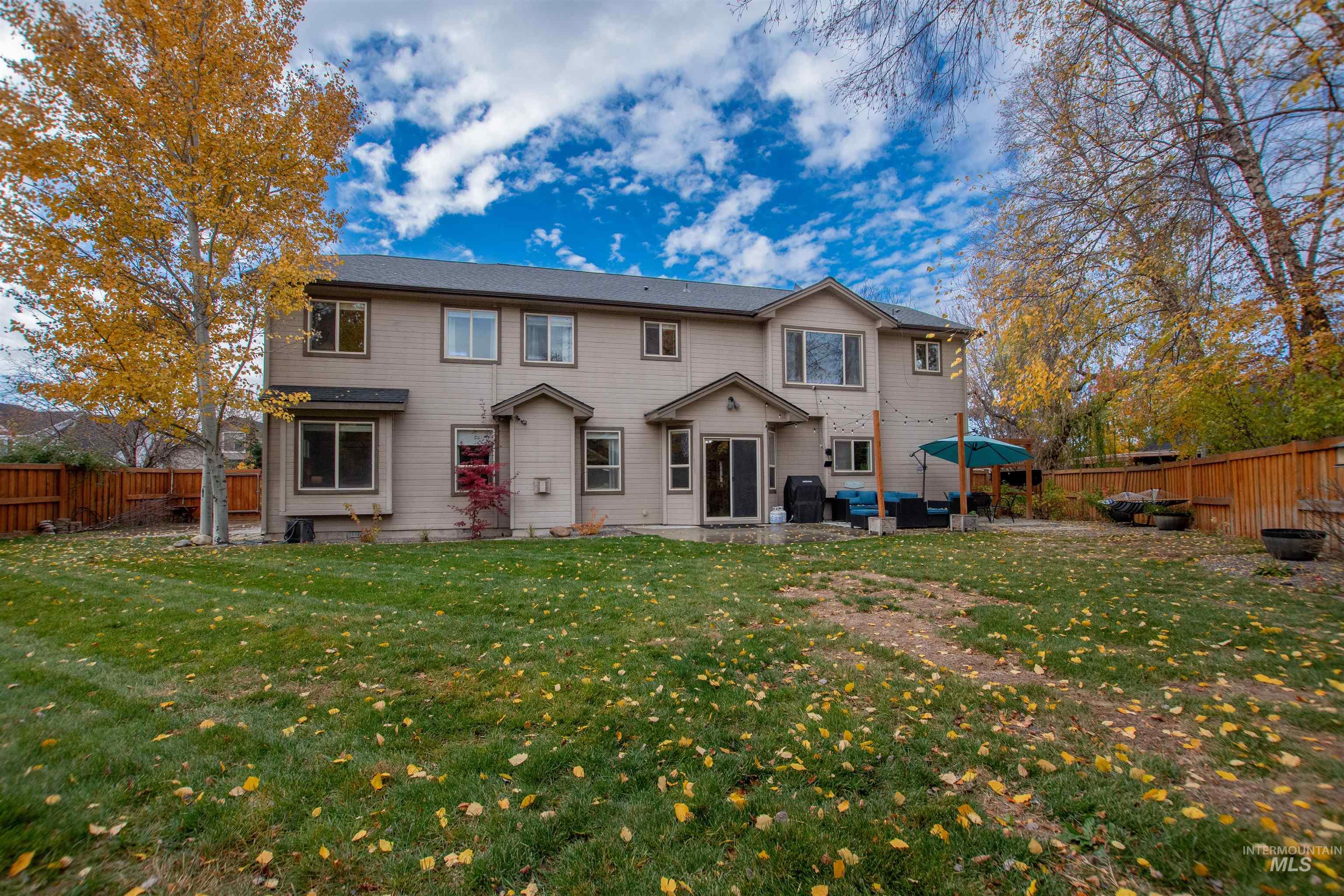 View of front of house featuring a fenced backyard and a patio area