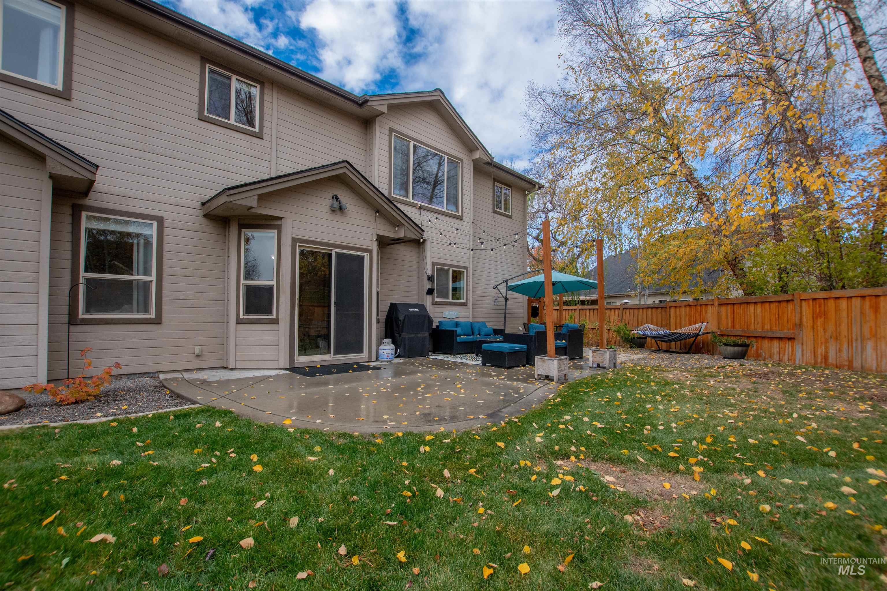 Rear view of house featuring a patio and an outdoor living space