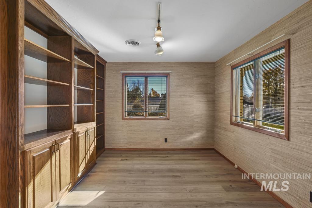 Unfurnished dining area with light wood-type flooring and plenty of natural light