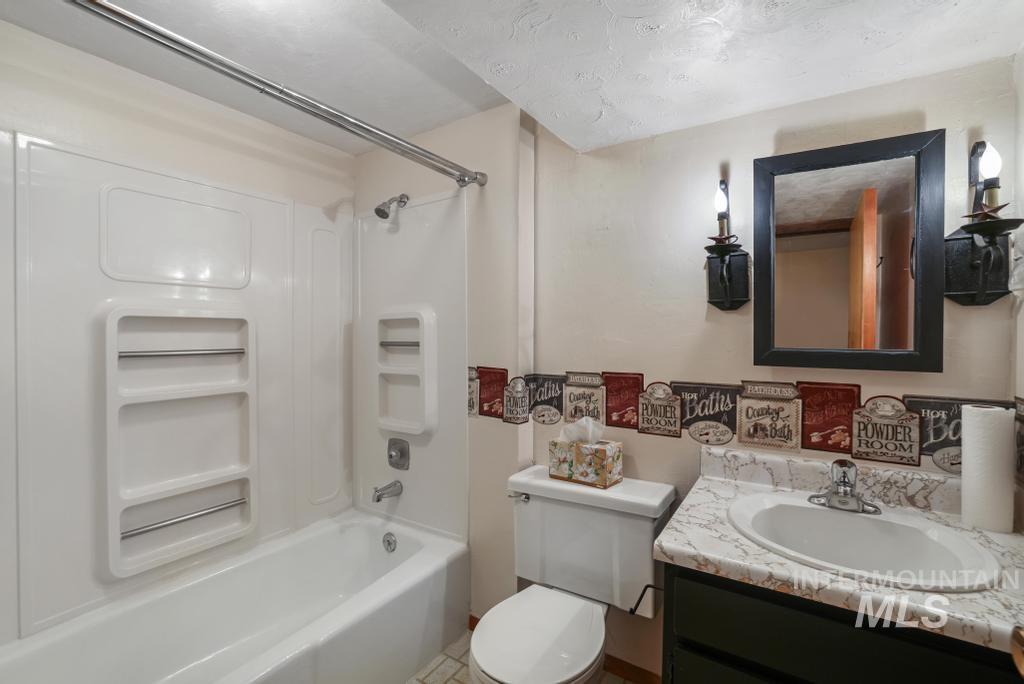 Full bathroom with bathing tub / shower combination and vanity