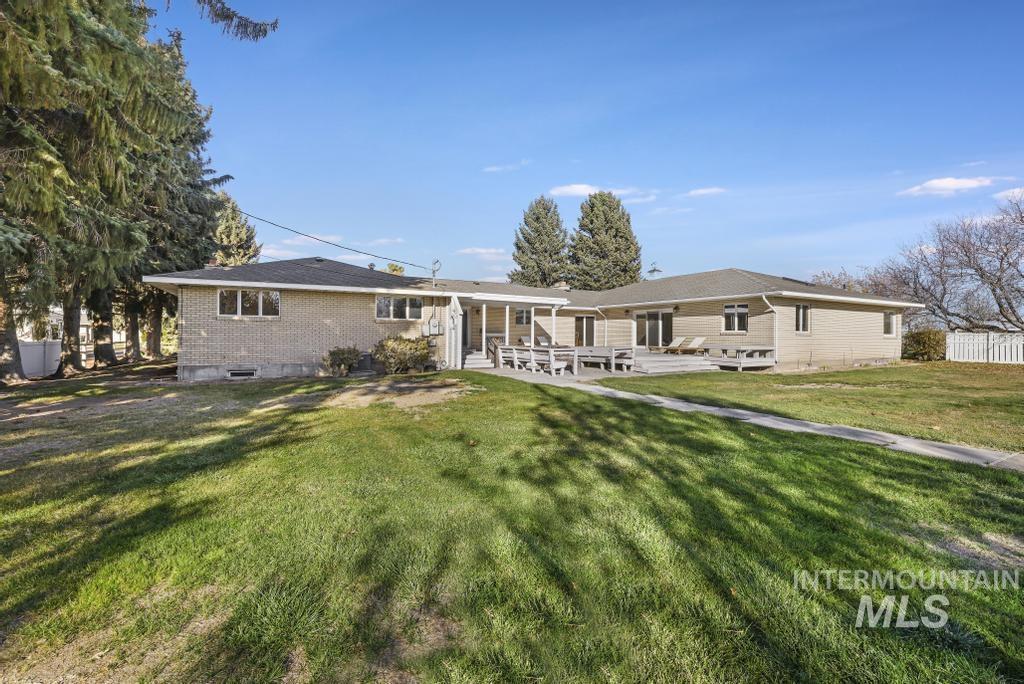 Rear view of property with brick siding and a patio area