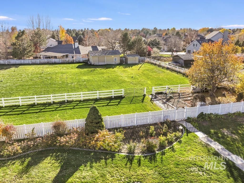 View of rural area with a pastoral area and a tree filled landscape