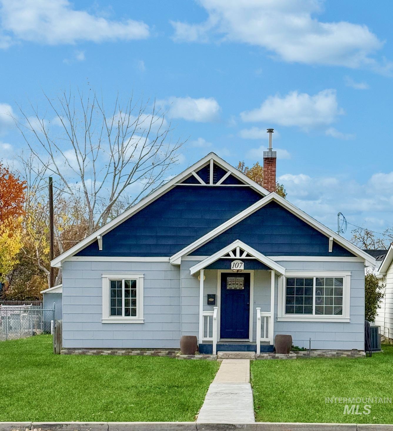 Bungalow-style house featuring a chimney