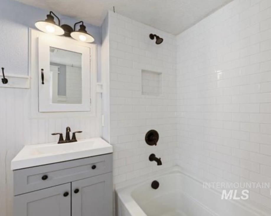 Bathroom featuring bathtub / shower combination and vanity