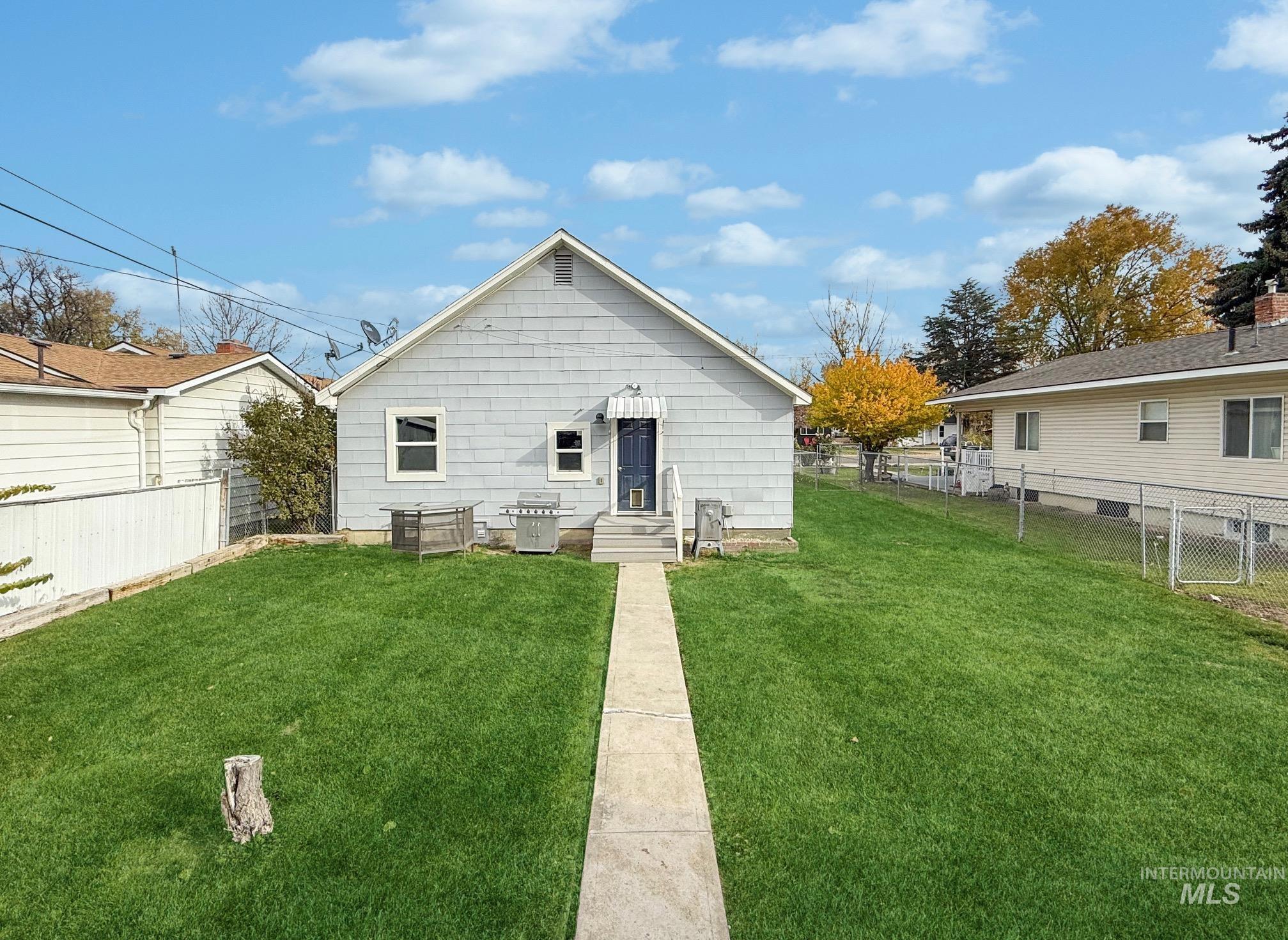 Back of property with a fenced backyard