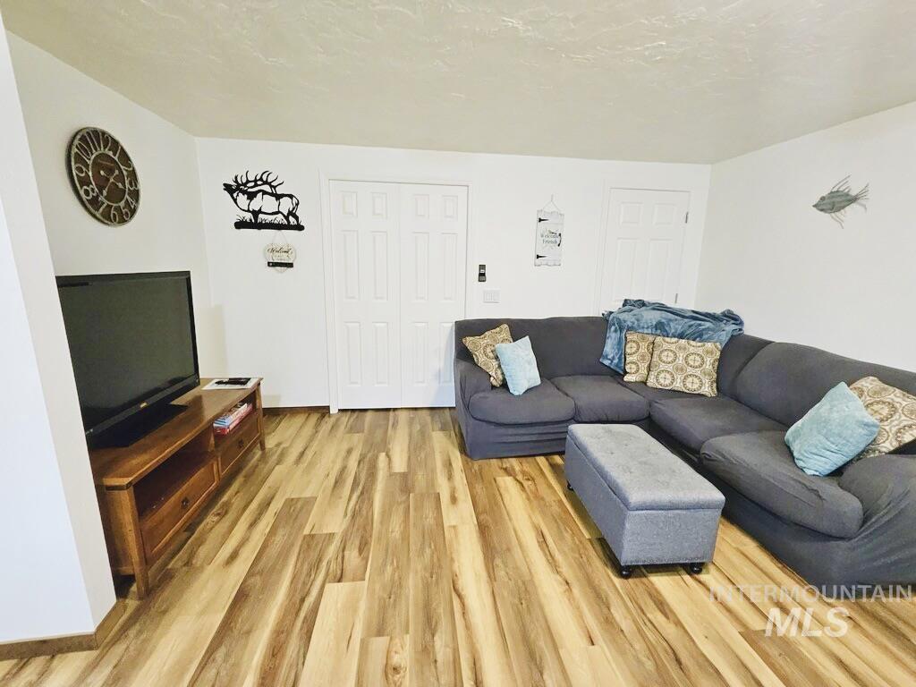 Living area featuring wood finished floors and a textured ceiling