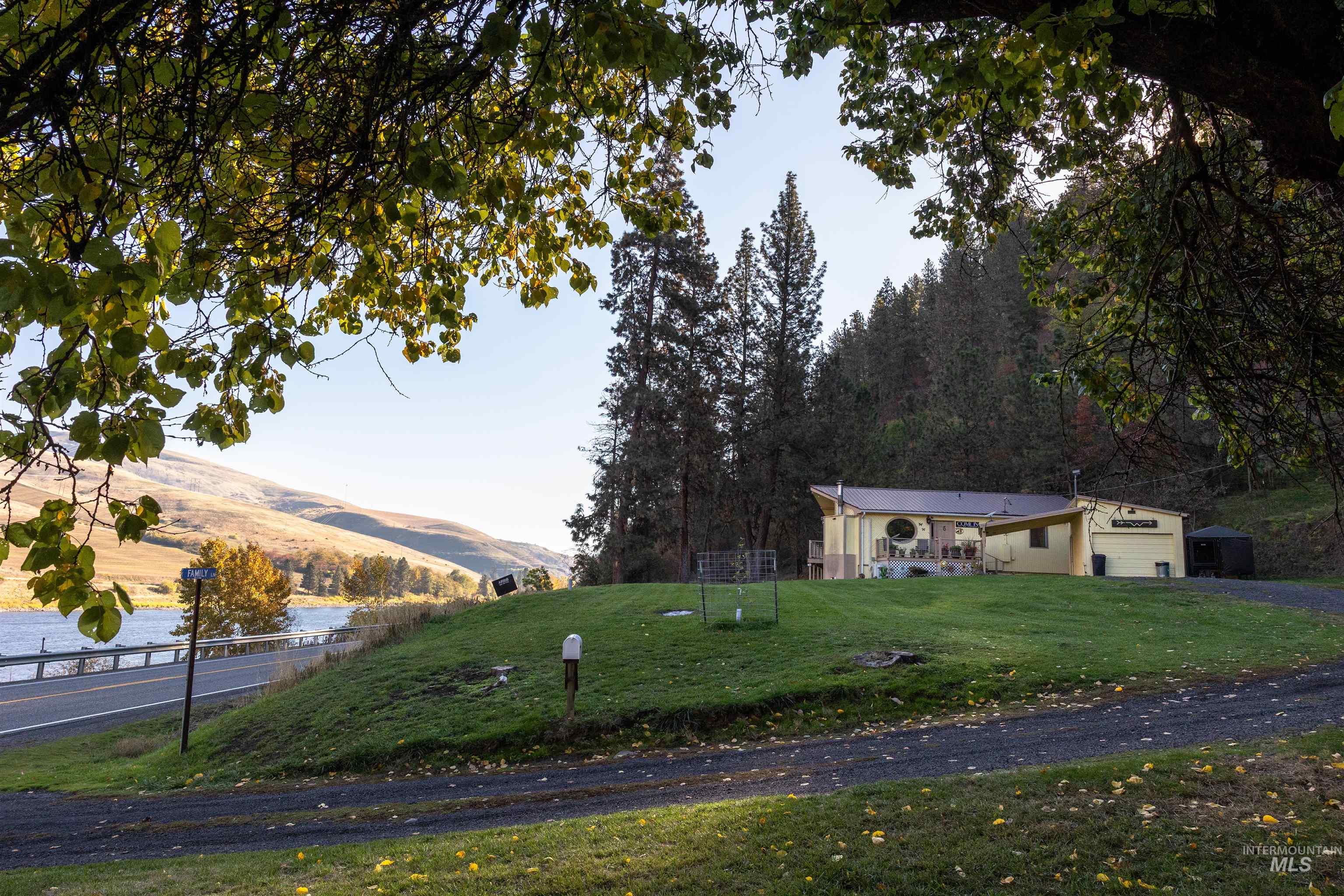 View of front of property with an attached garage, driveway, and a mountain view