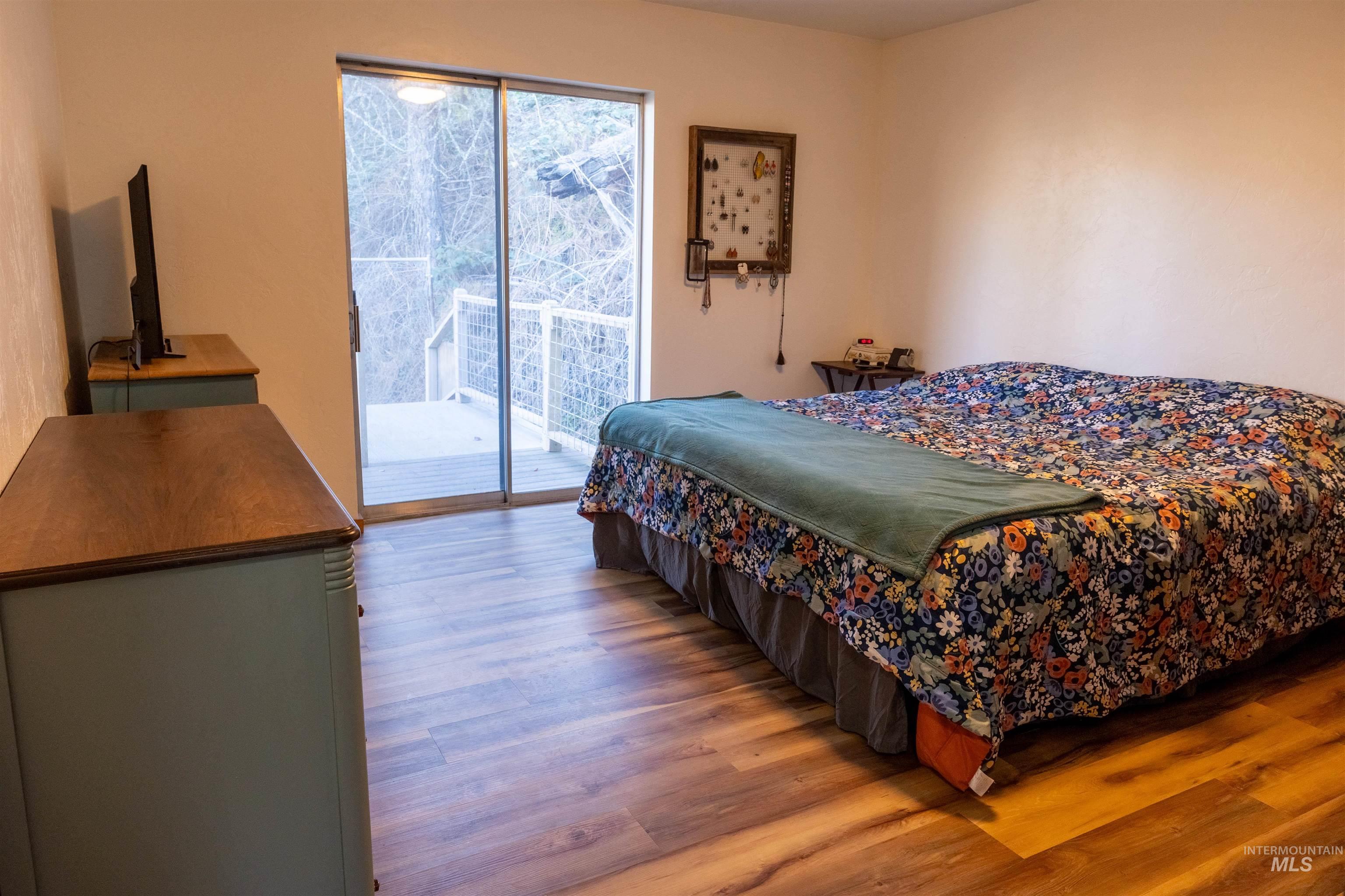 Bedroom featuring wood finished floors and access to outside