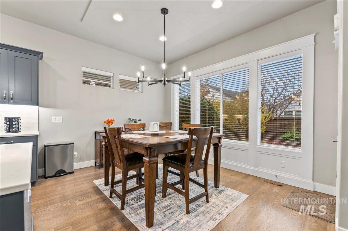 Dining room featuring light wood-style flooring, recessed lighting, and a chandelier