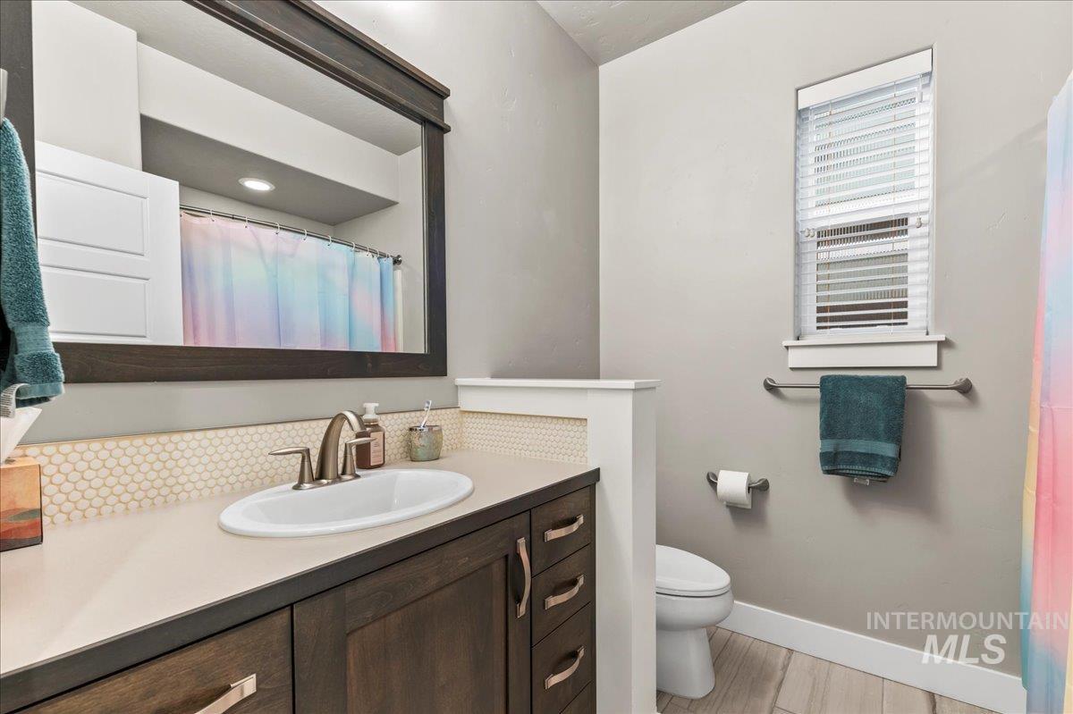 Bathroom with a shower with shower curtain and vanity