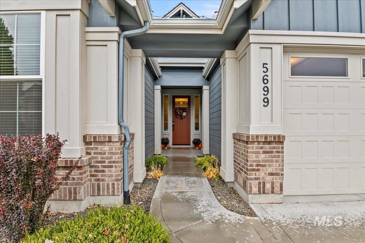 Entrance to property featuring brick siding and board and batten siding
