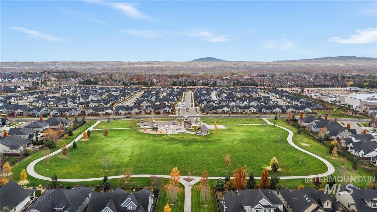 Aerial overview of property's location featuring nearby suburban area and mountains
