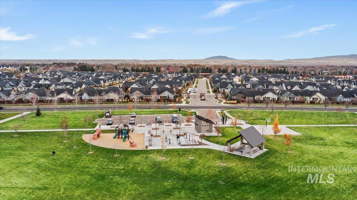 Aerial view of residential area with a park and mountains