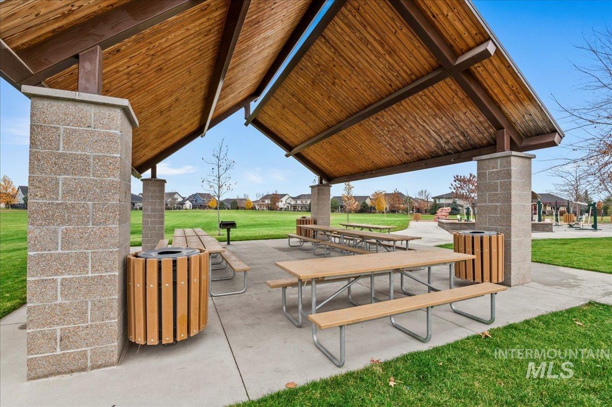View of property's community with a yard, a residential view, and a patio area