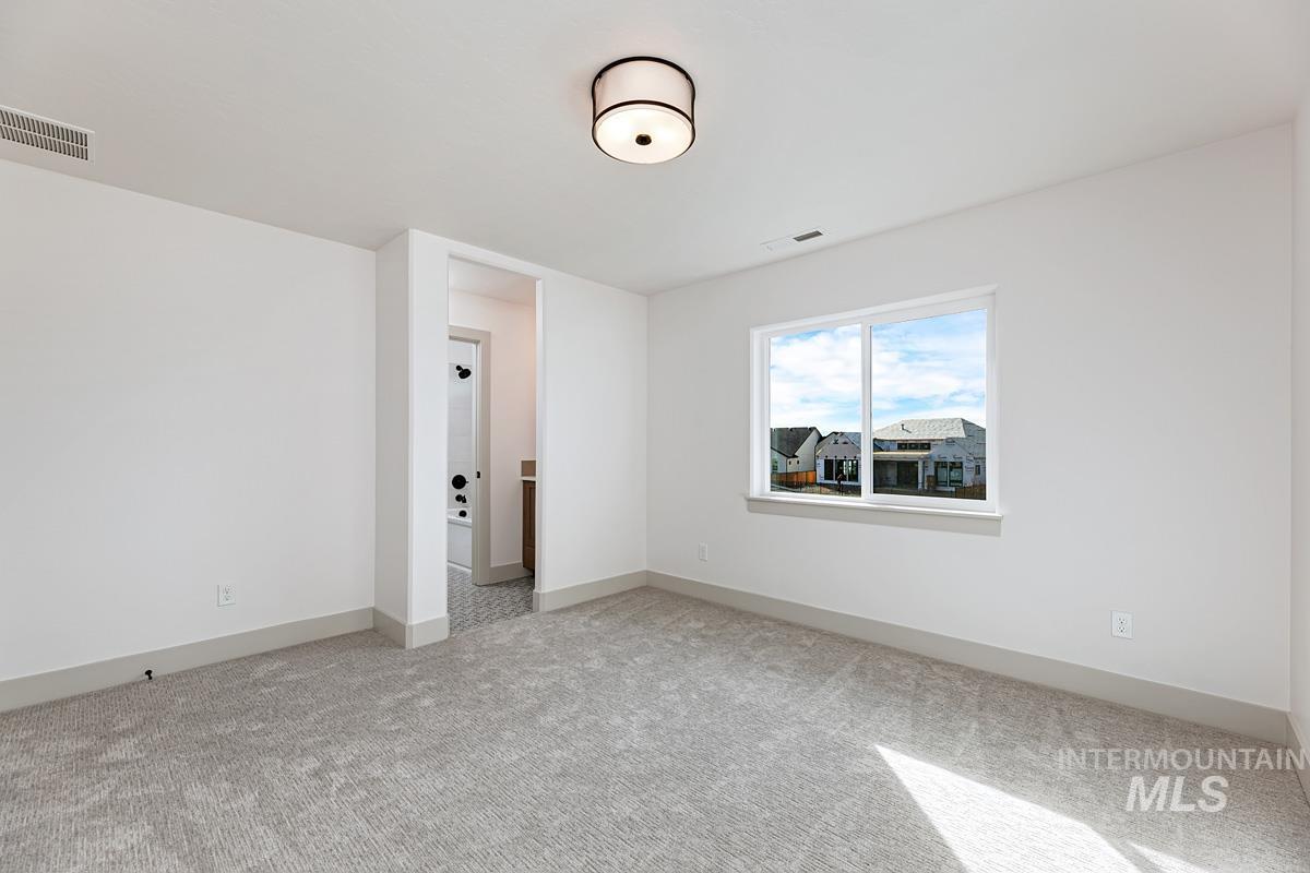 Empty room featuring baseboards and light colored carpet
