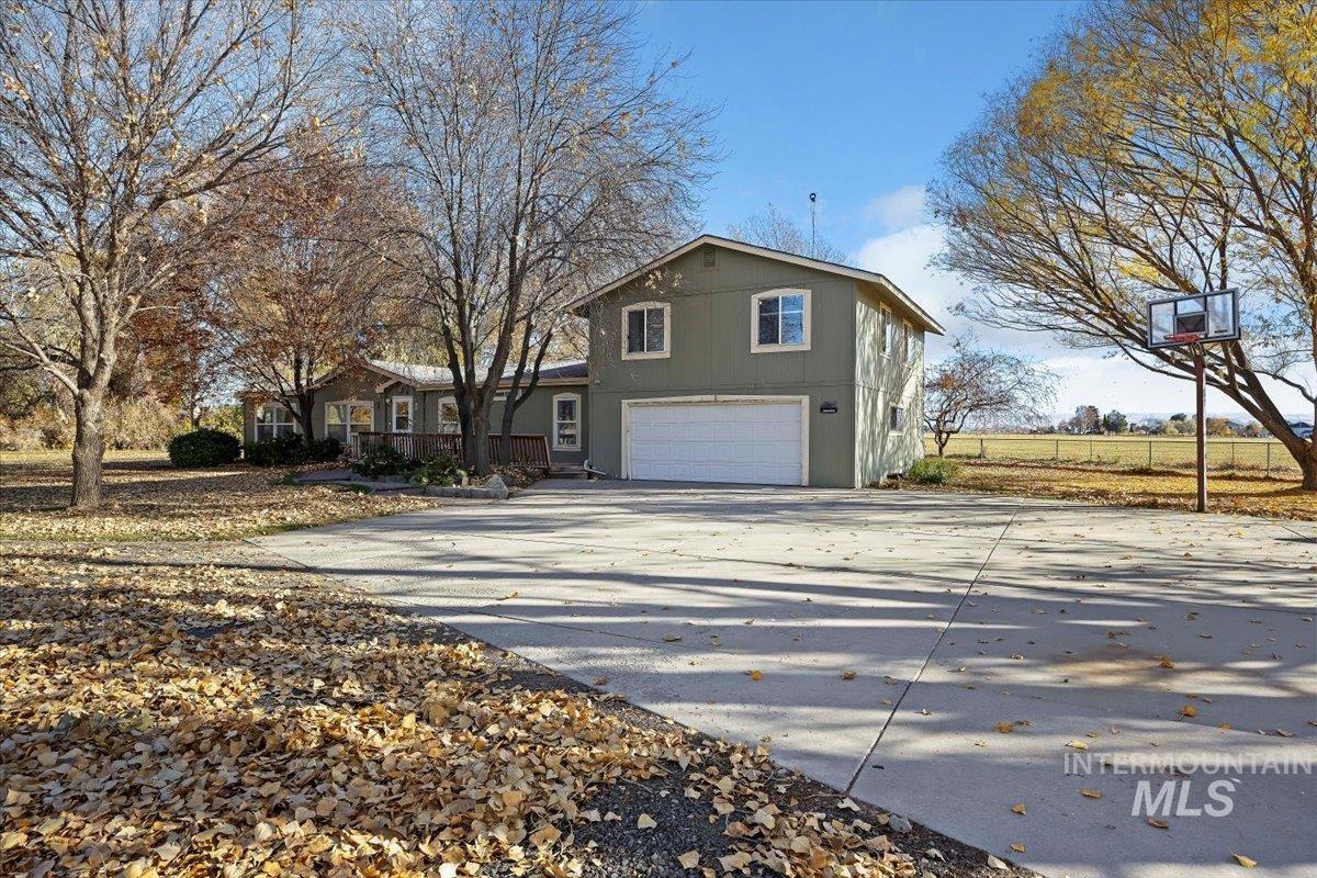 View of front of property with driveway and a garage