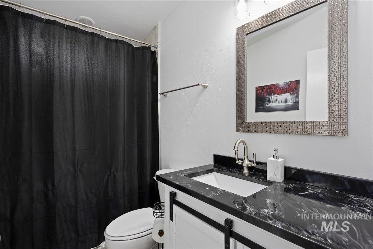 Full bath with vanity and a shower with curtain