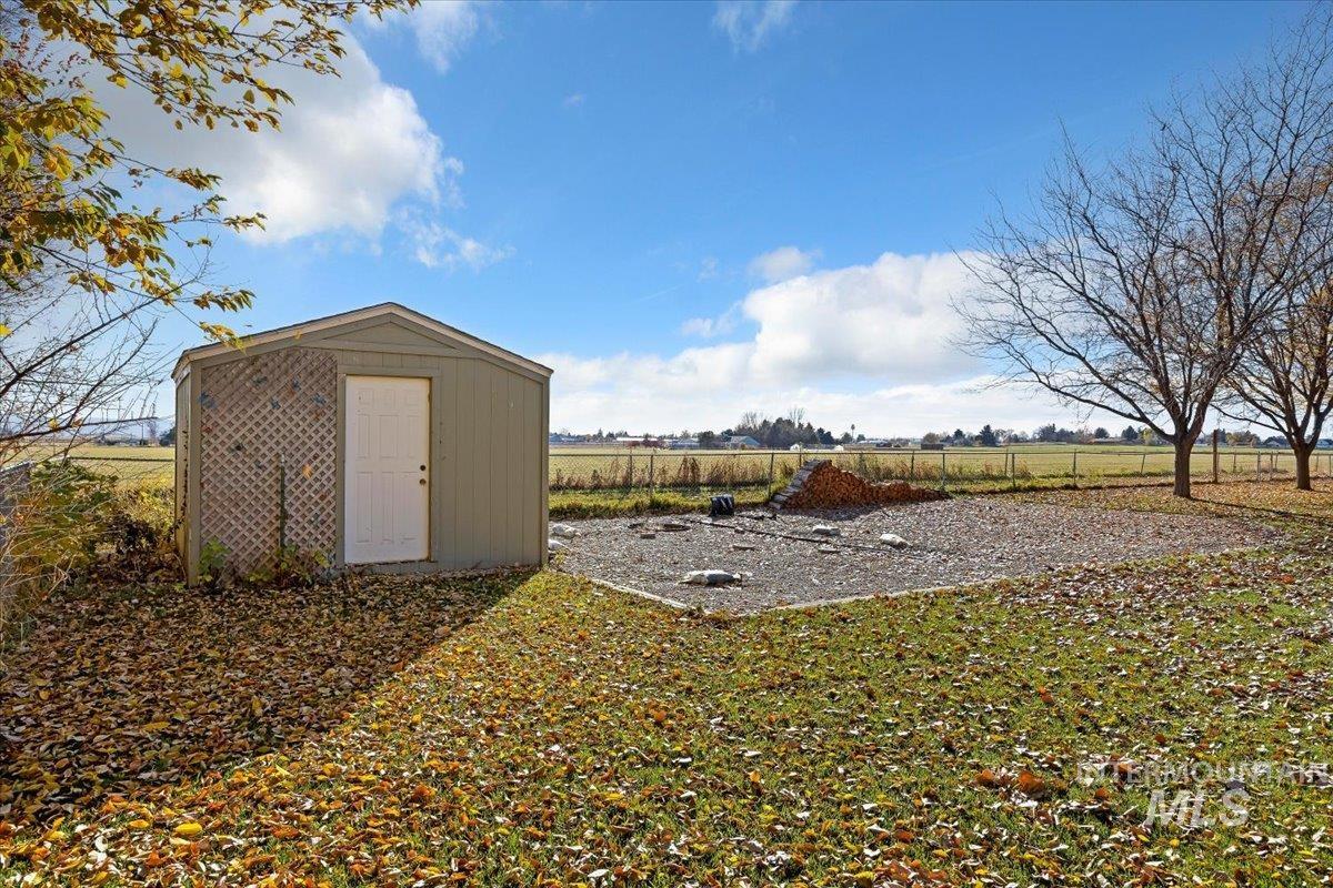 View of yard featuring a storage shed and a view of countryside