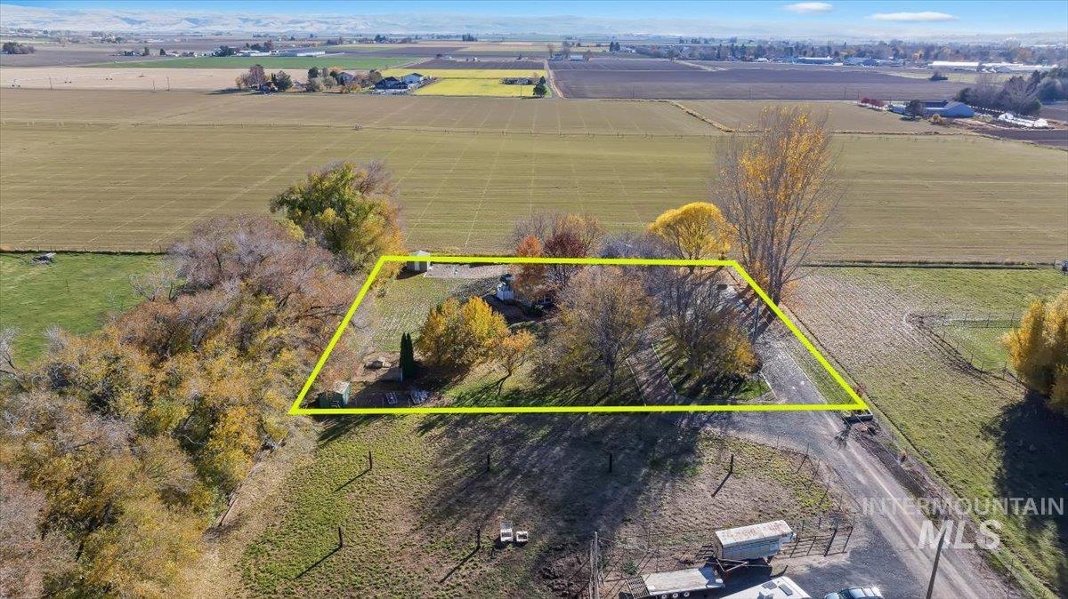 Aerial view of sparsely populated area with property parcel outlined