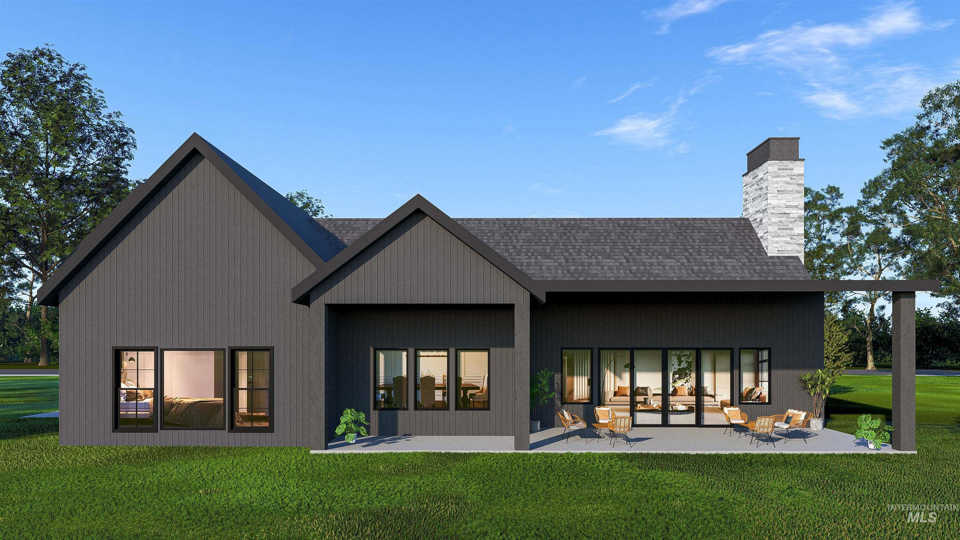Back of property featuring a yard, a chimney, a patio, and a shingled roof