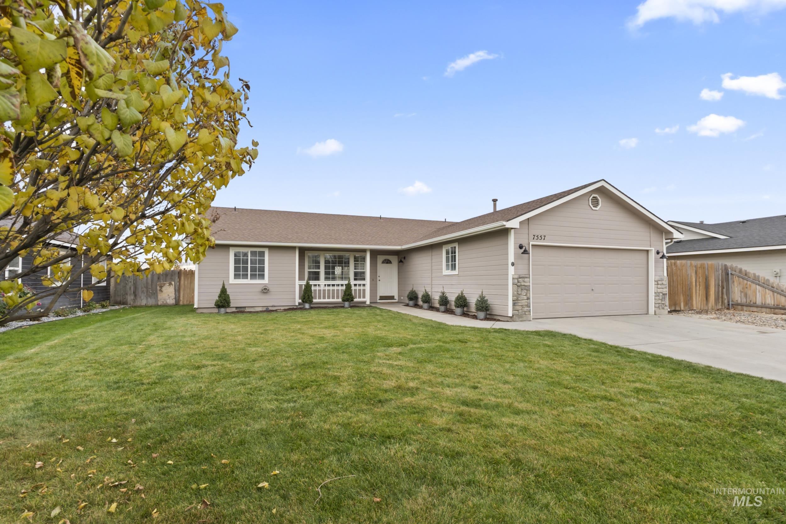 Single story home with concrete driveway and a garage