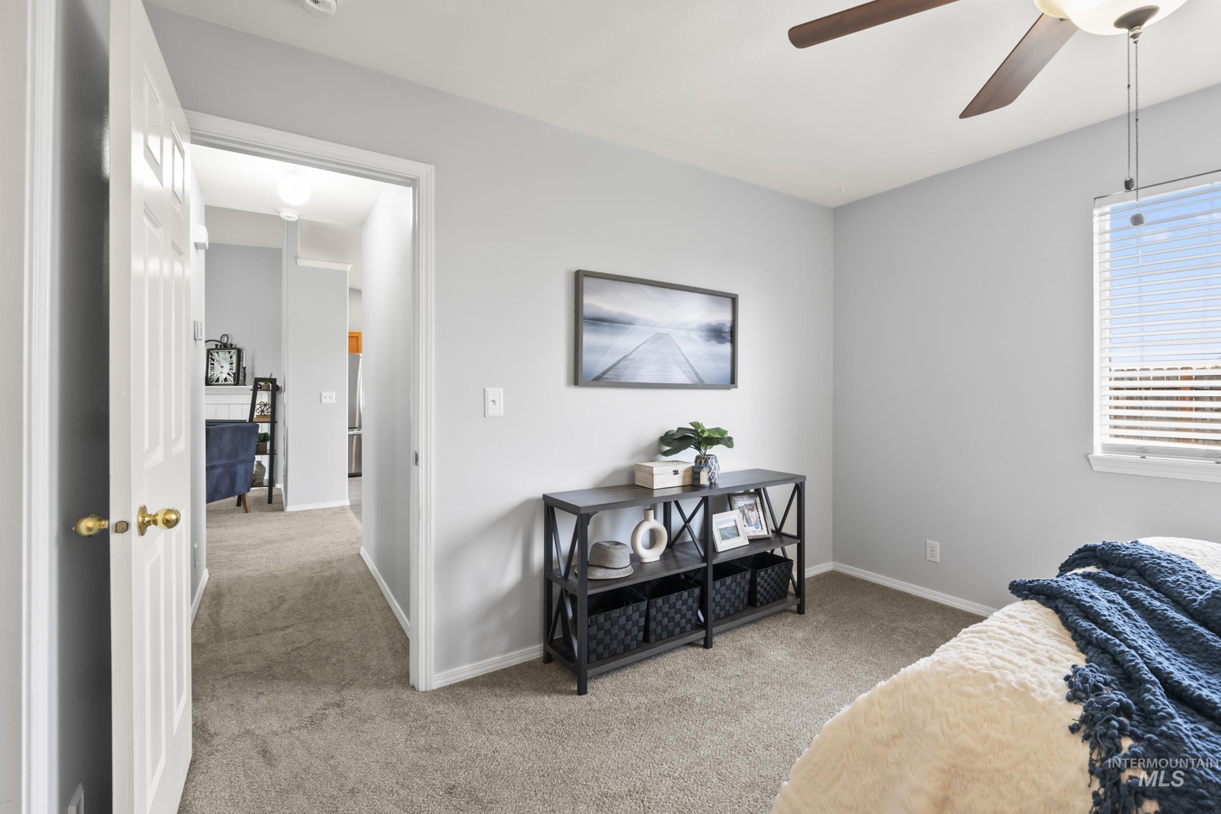 Bedroom with light carpet and ceiling fan