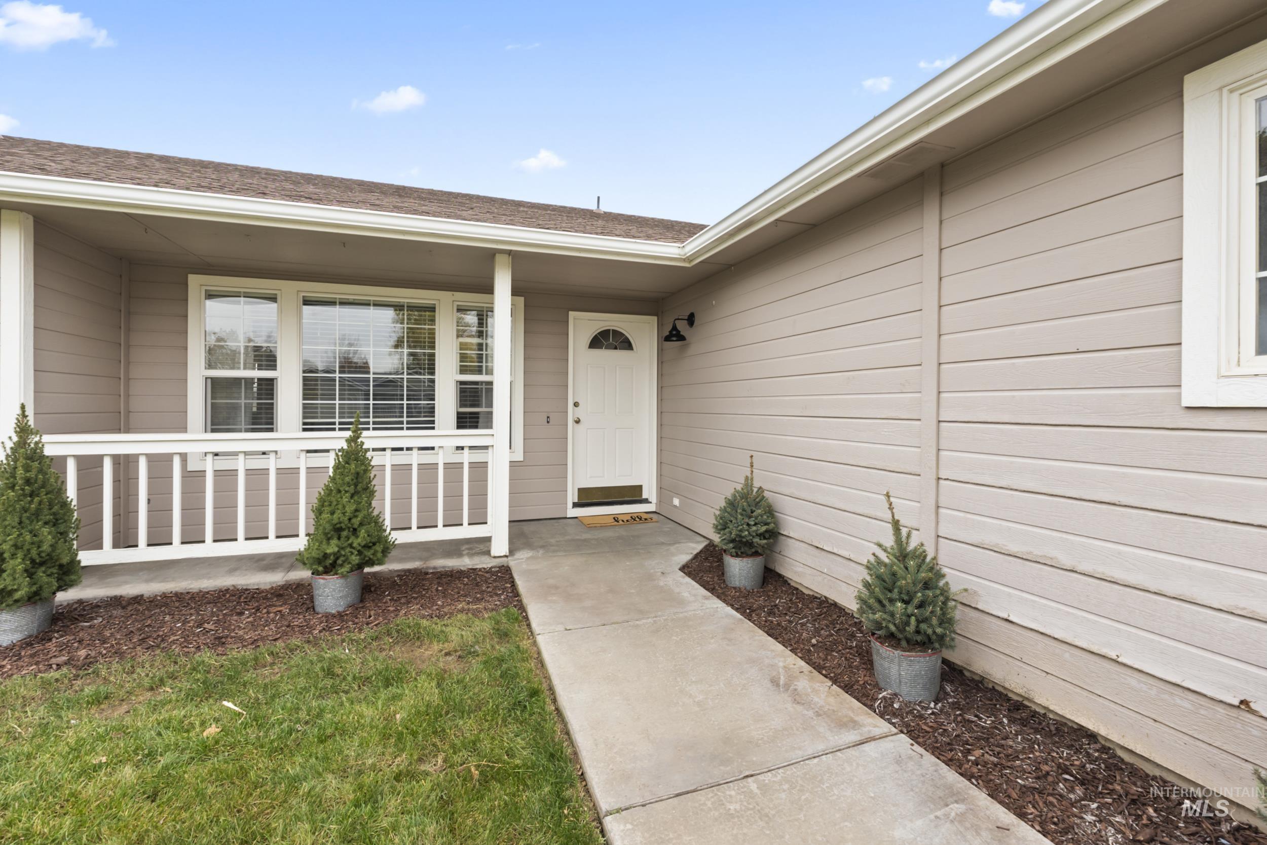 Doorway to property featuring a shingled roof
