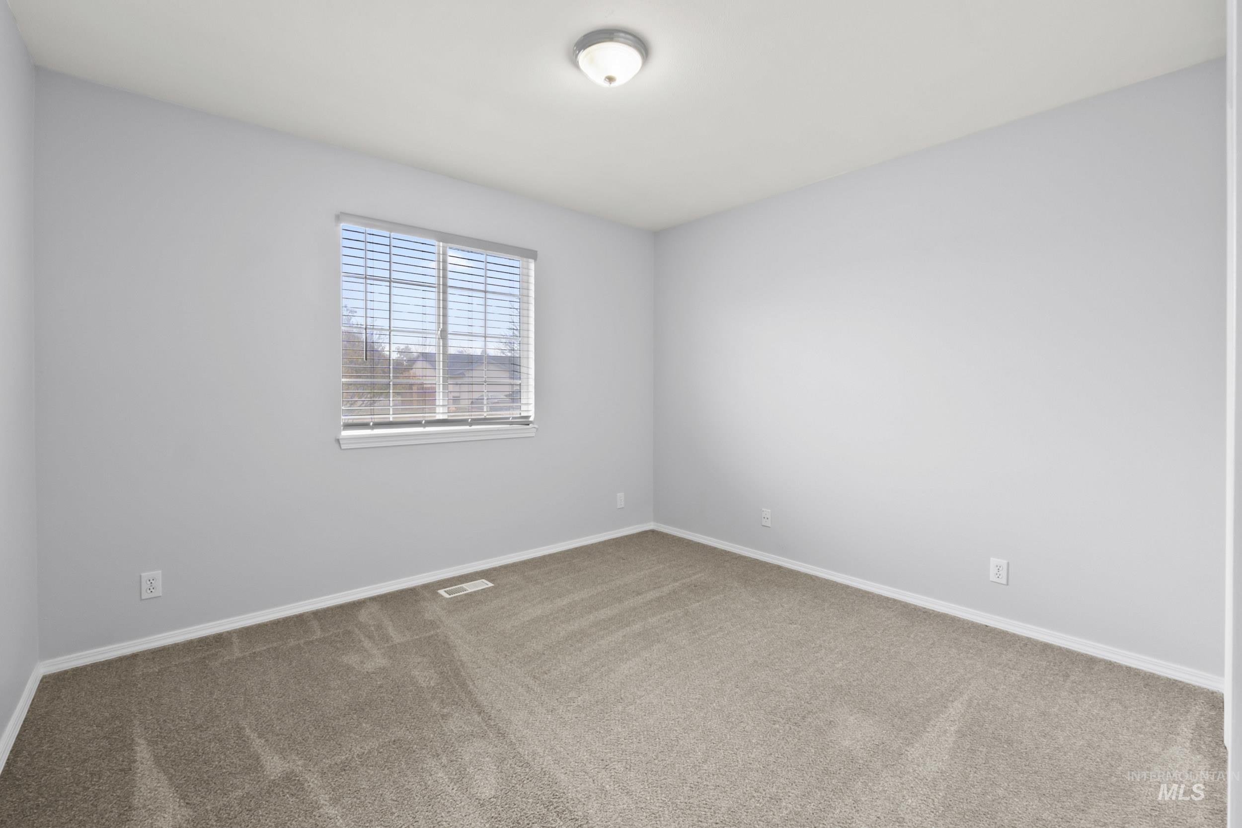 Unfurnished room featuring carpet flooring and baseboards