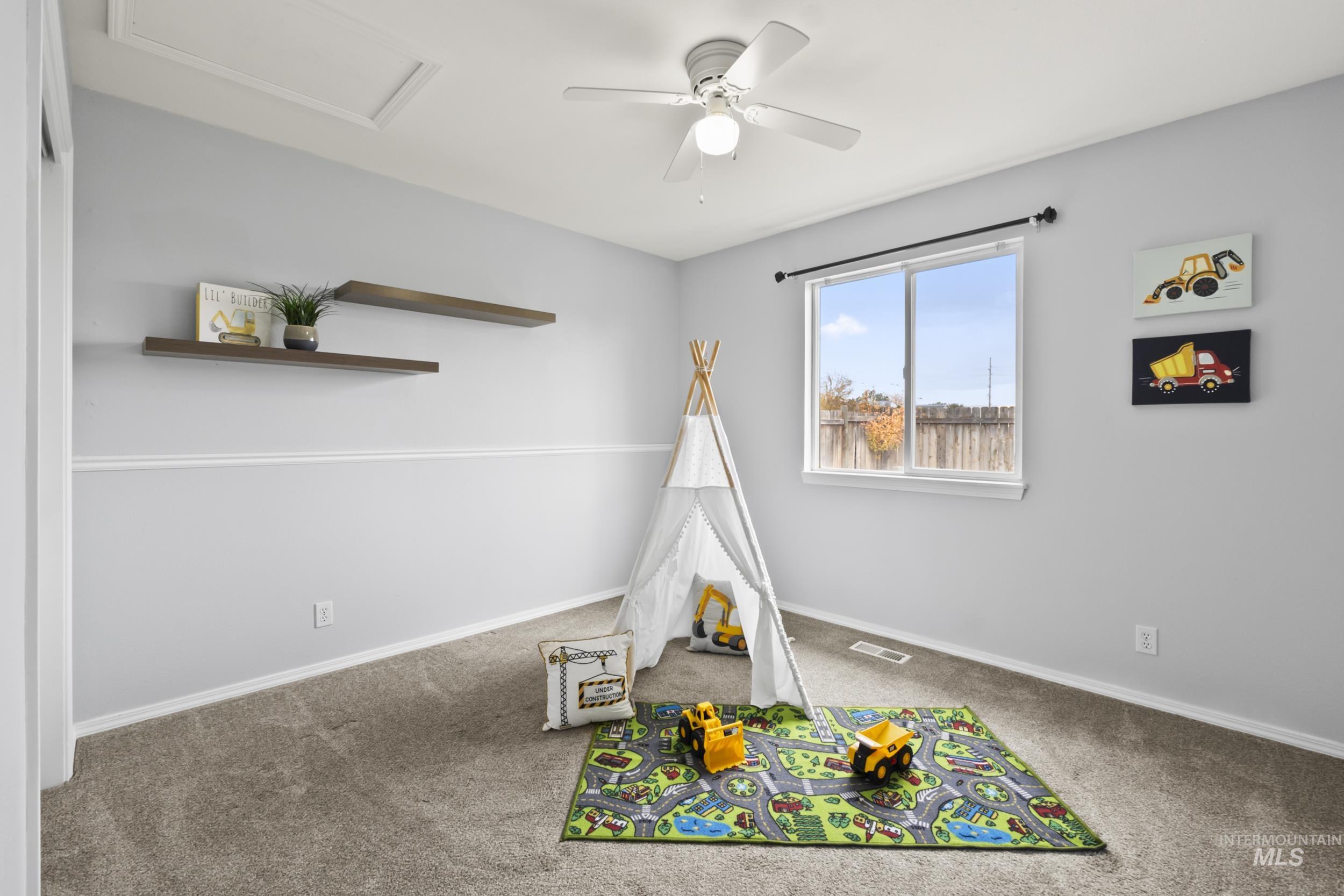 Featuring carpet, ceiling fan, and attic access