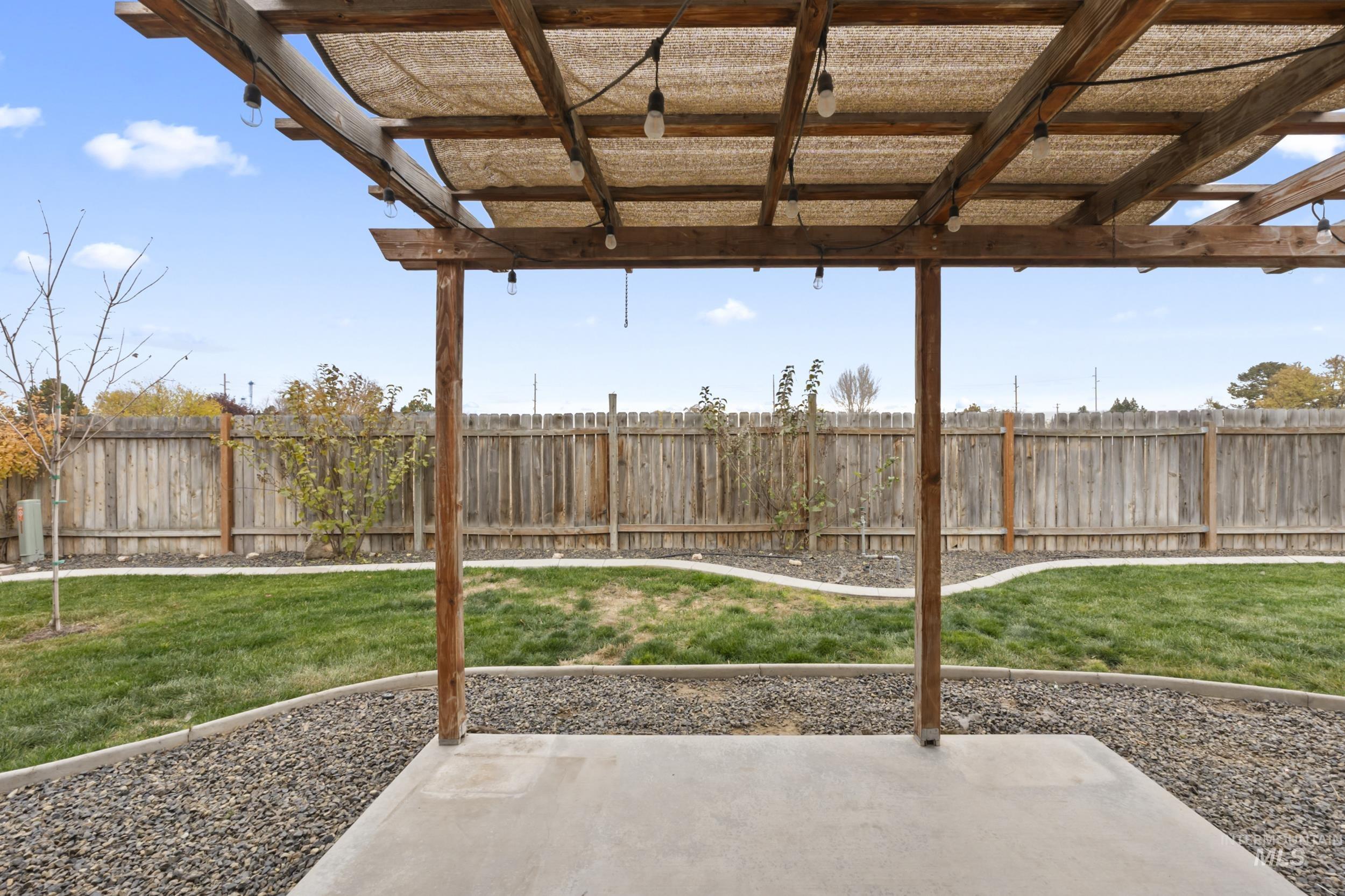 Fenced backyard featuring a patio area with pergola