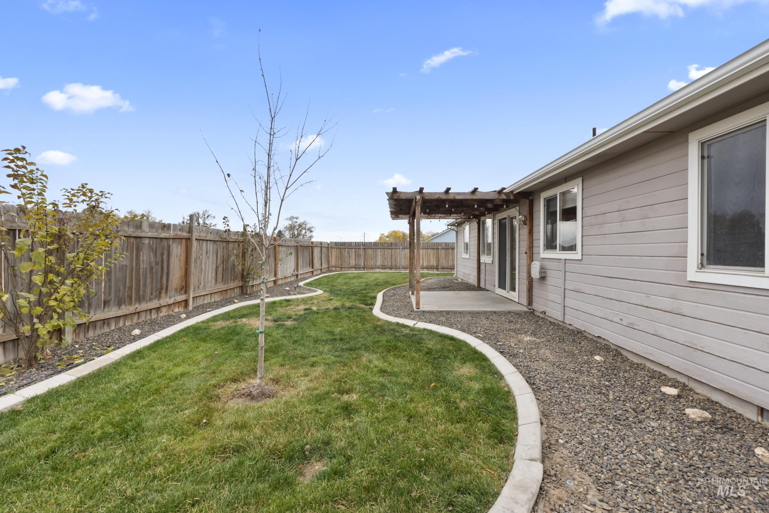 Fenced backyard with a patio area and a pergola