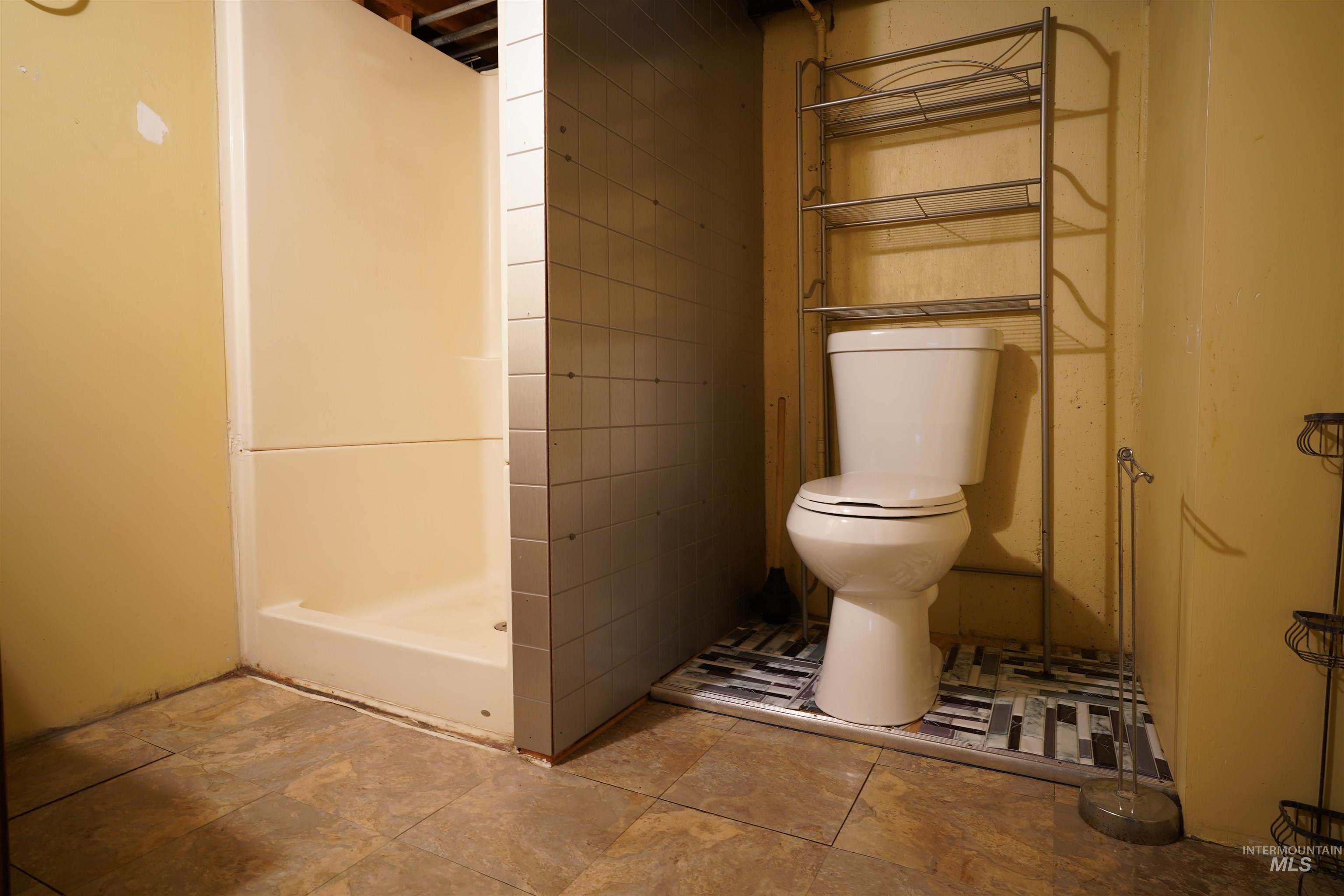 Bathroom with a stall shower and toilet