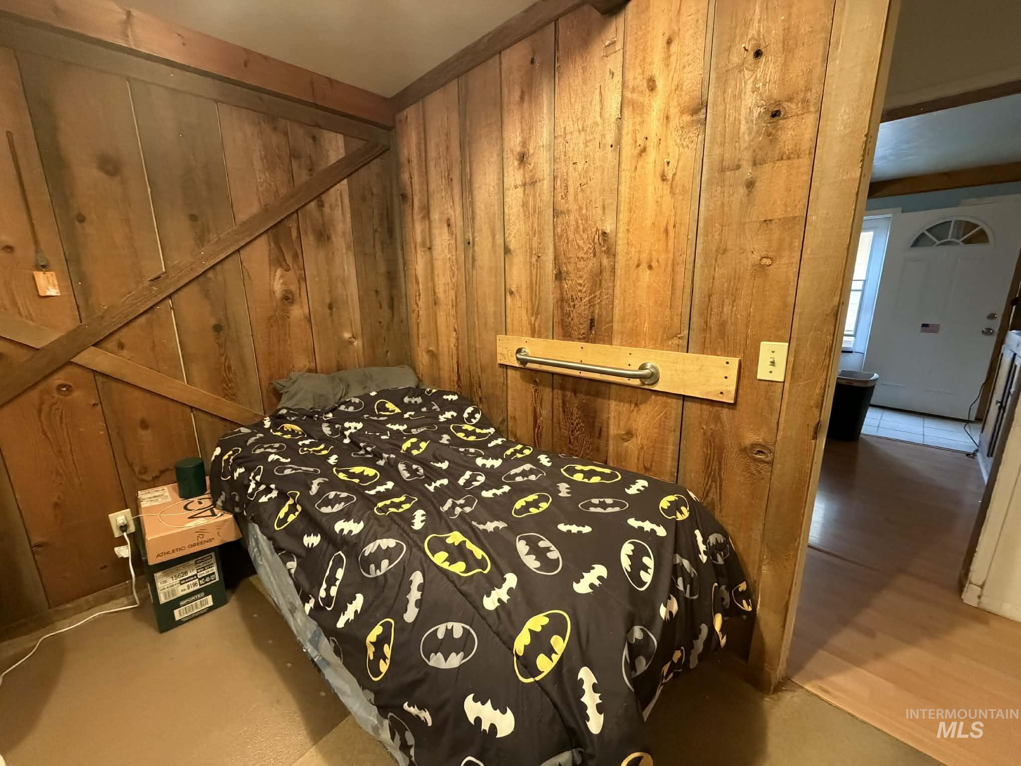 Bedroom with wood walls