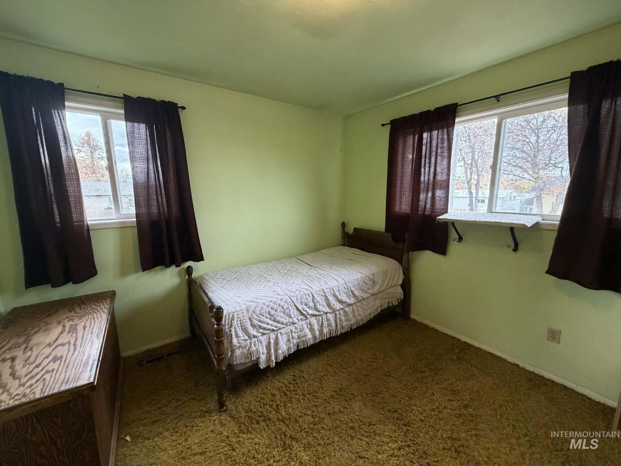 Bedroom featuring carpet floors and multiple windows