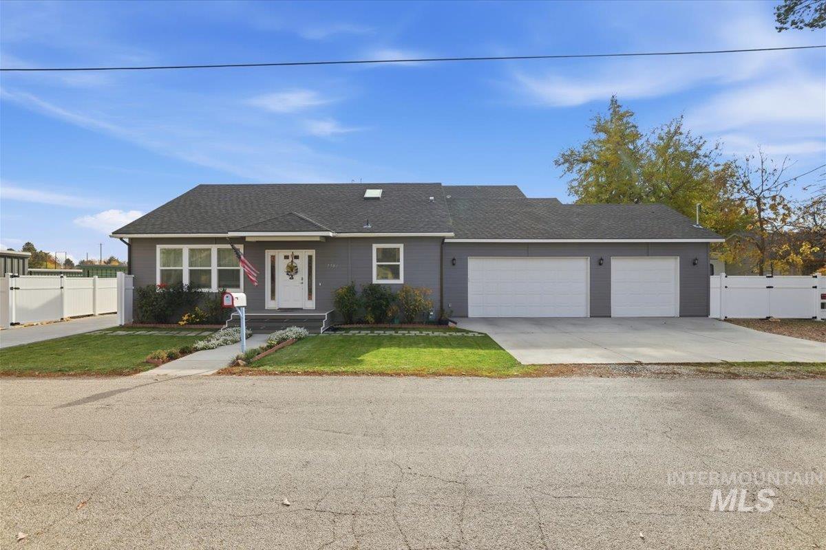 Ranch-style house featuring concrete driveway, a garage, and roof with shingles