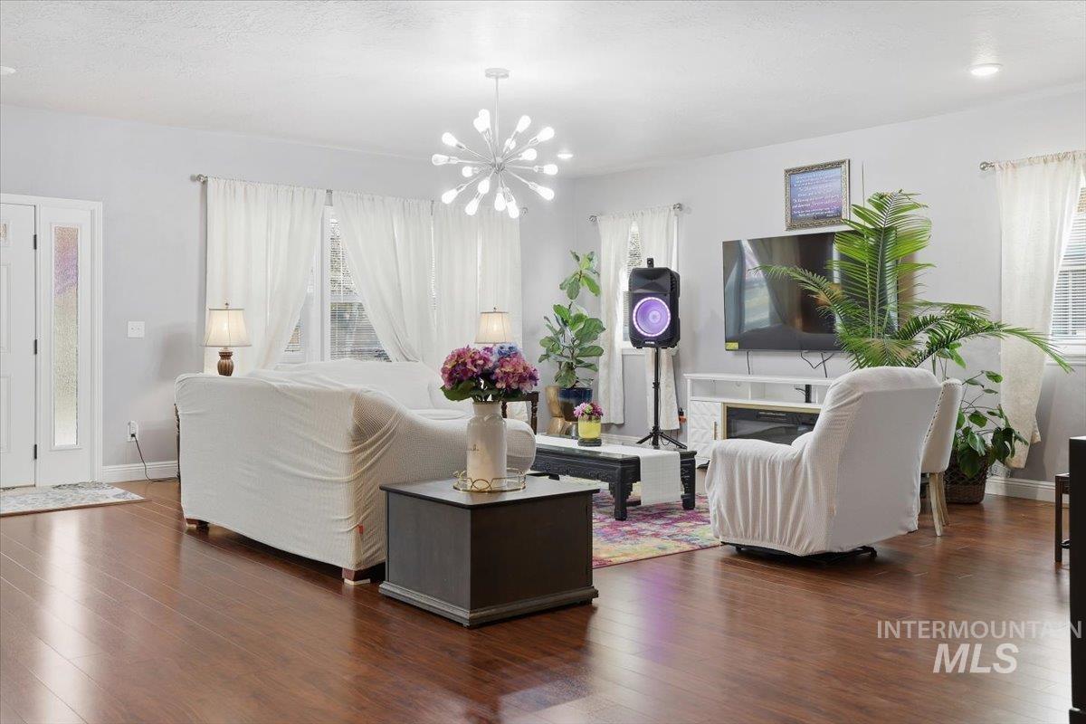 Living room with wood finished floors and a chandelier