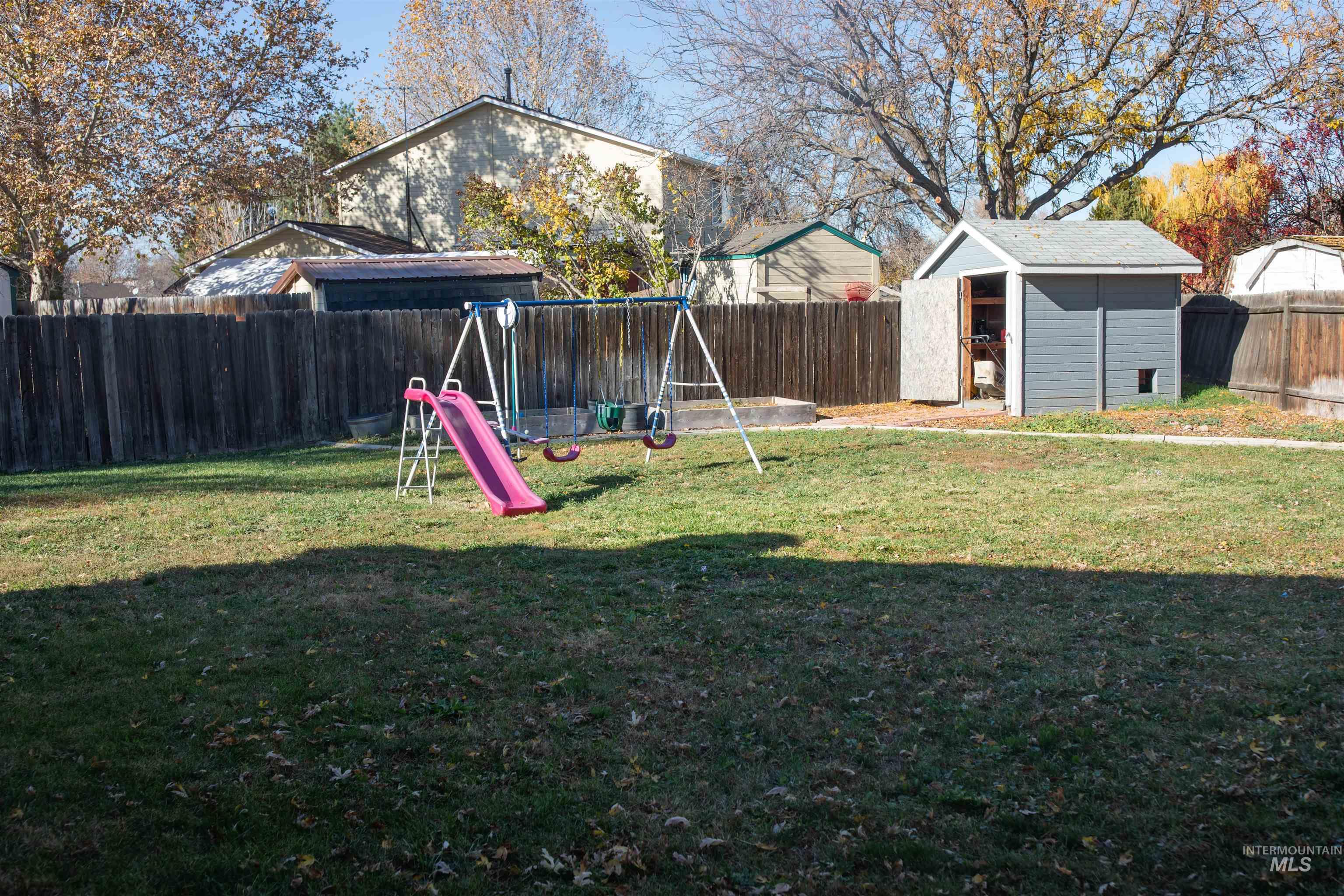 Fenced backyard with a shed