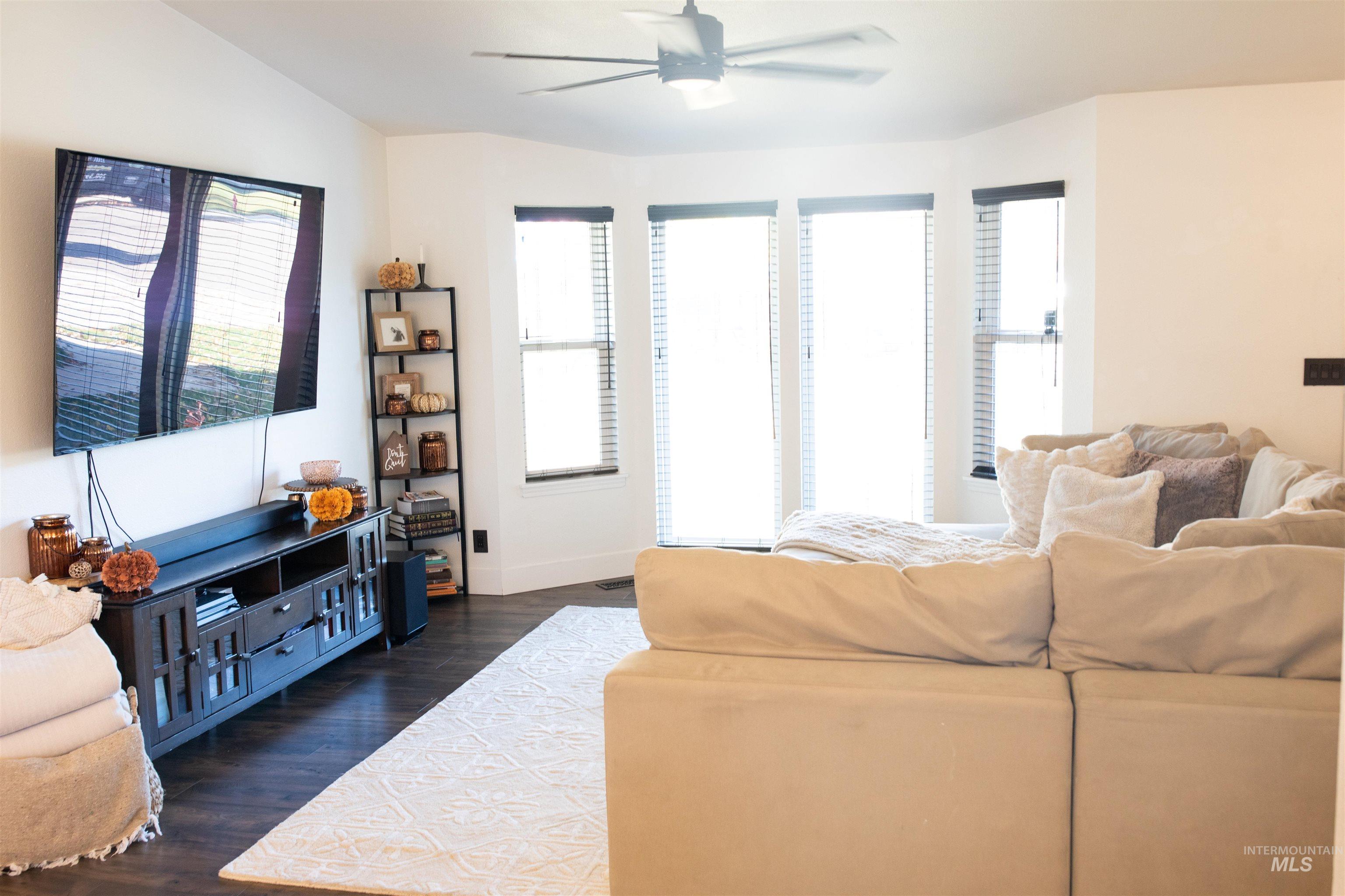 Living room with bayed windows and plenty of natural light