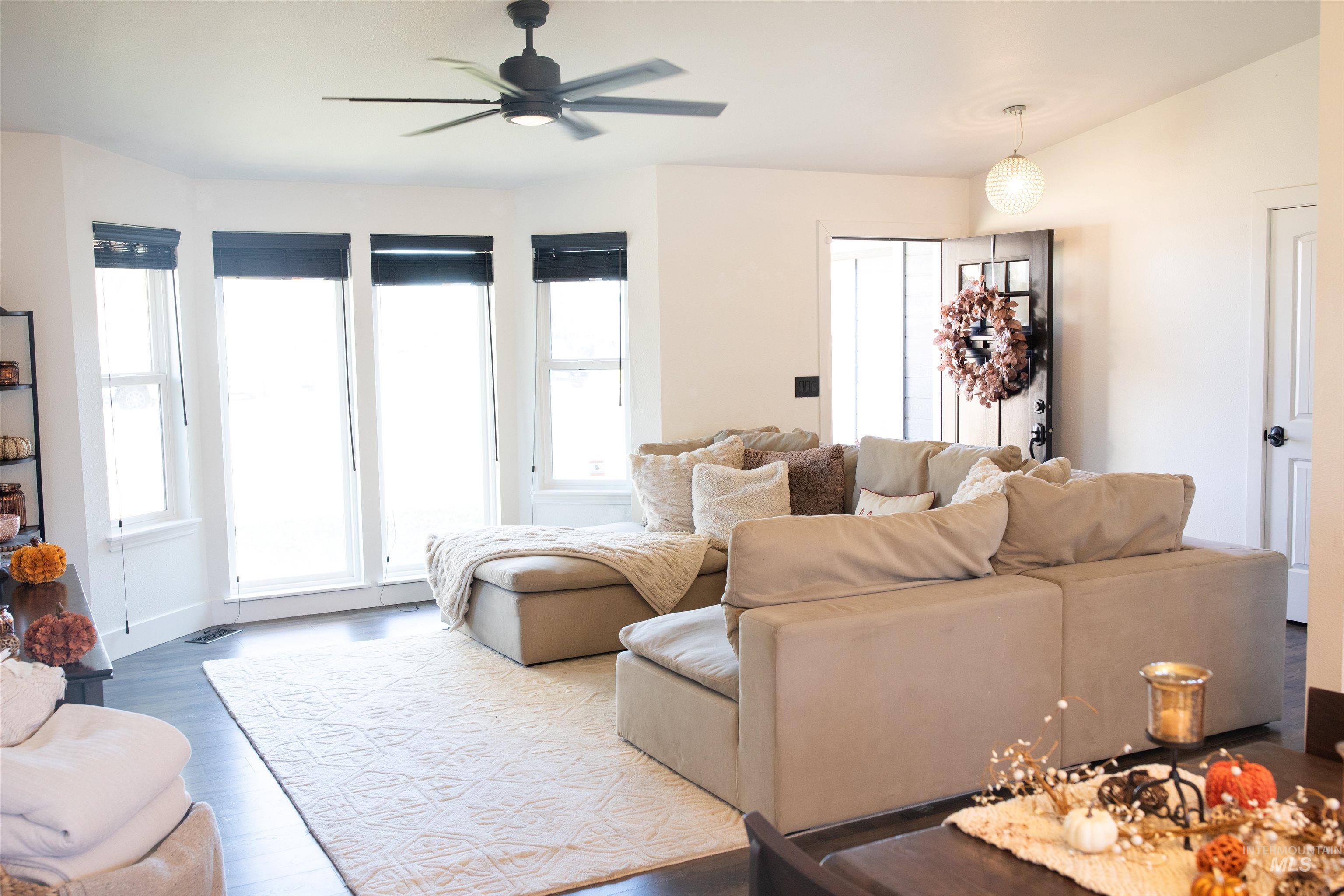 Living area featuring vaulted ceilings and dark wood floors