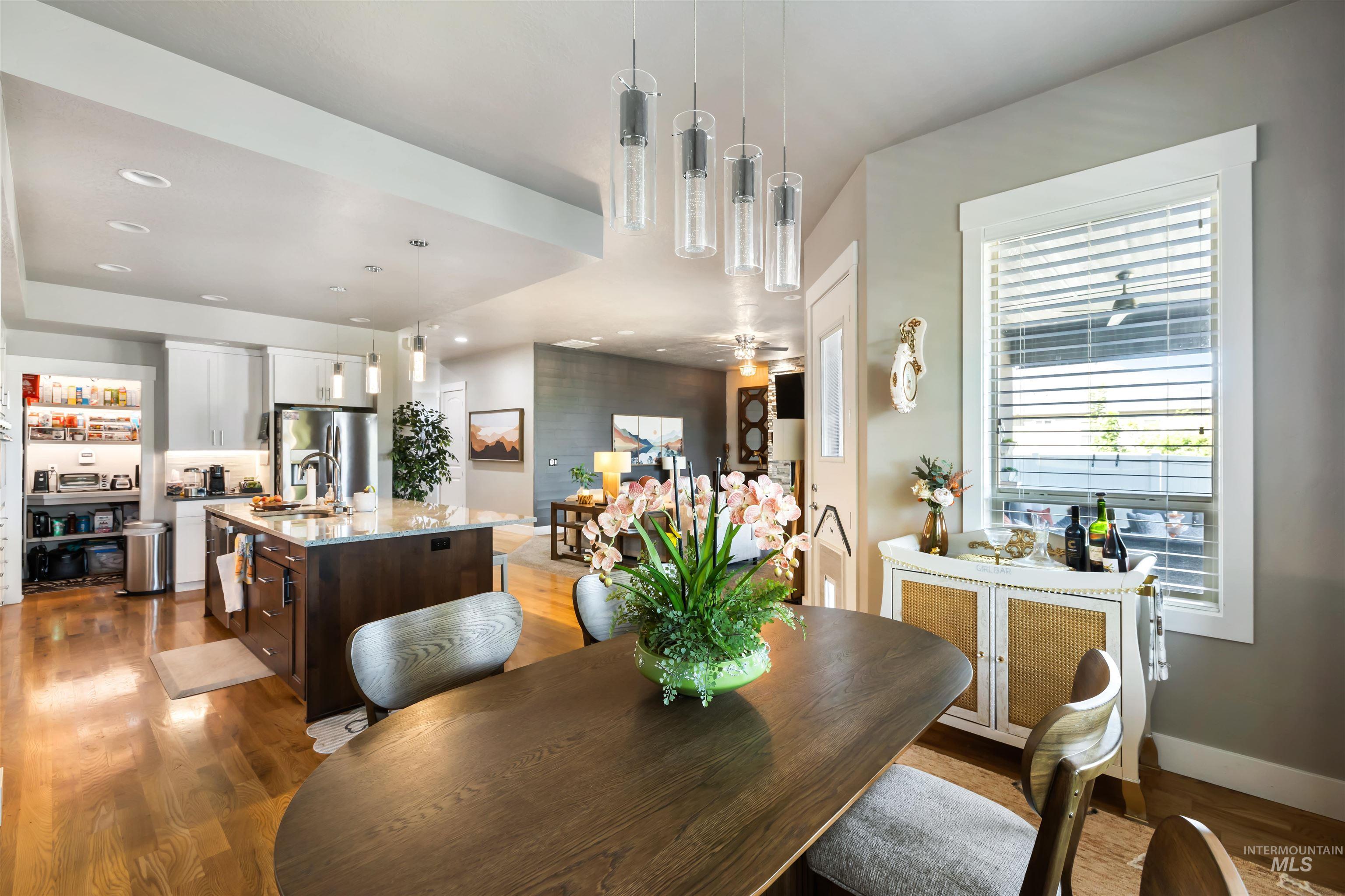 Dining area featuring light wood-type flooring, recessed lighting, and a ceiling fan