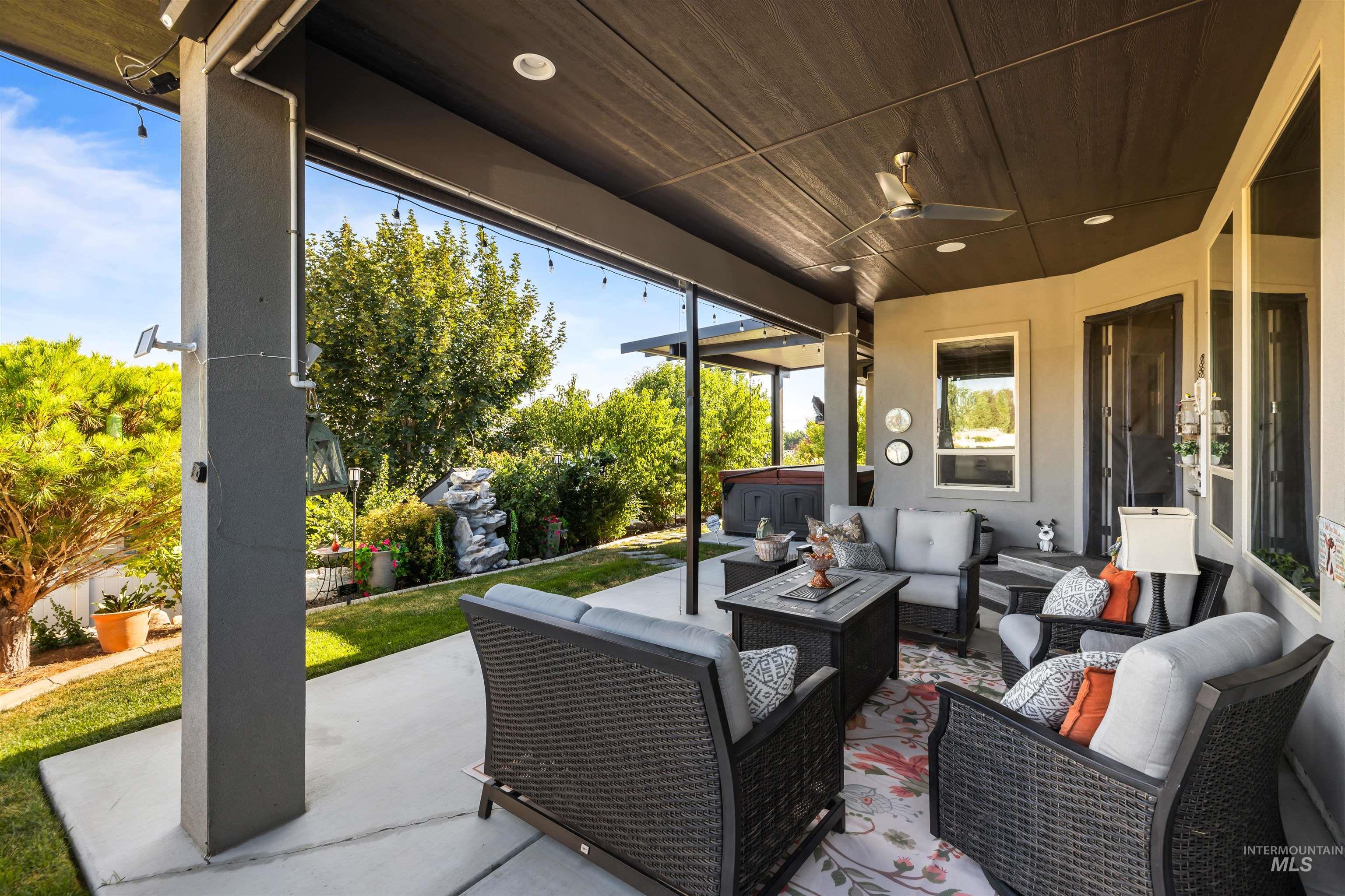 View of patio with outdoor lounge area and ceiling fan