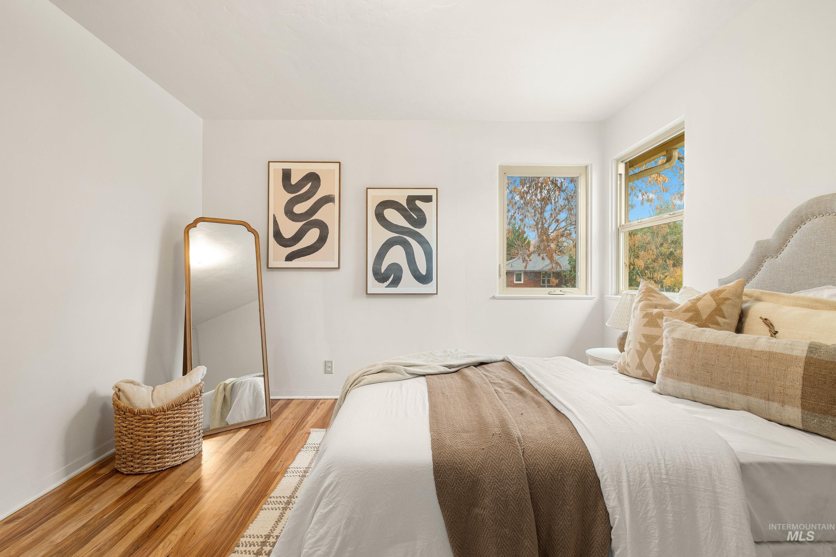 Bedroom featuring wood finished floors and baseboards