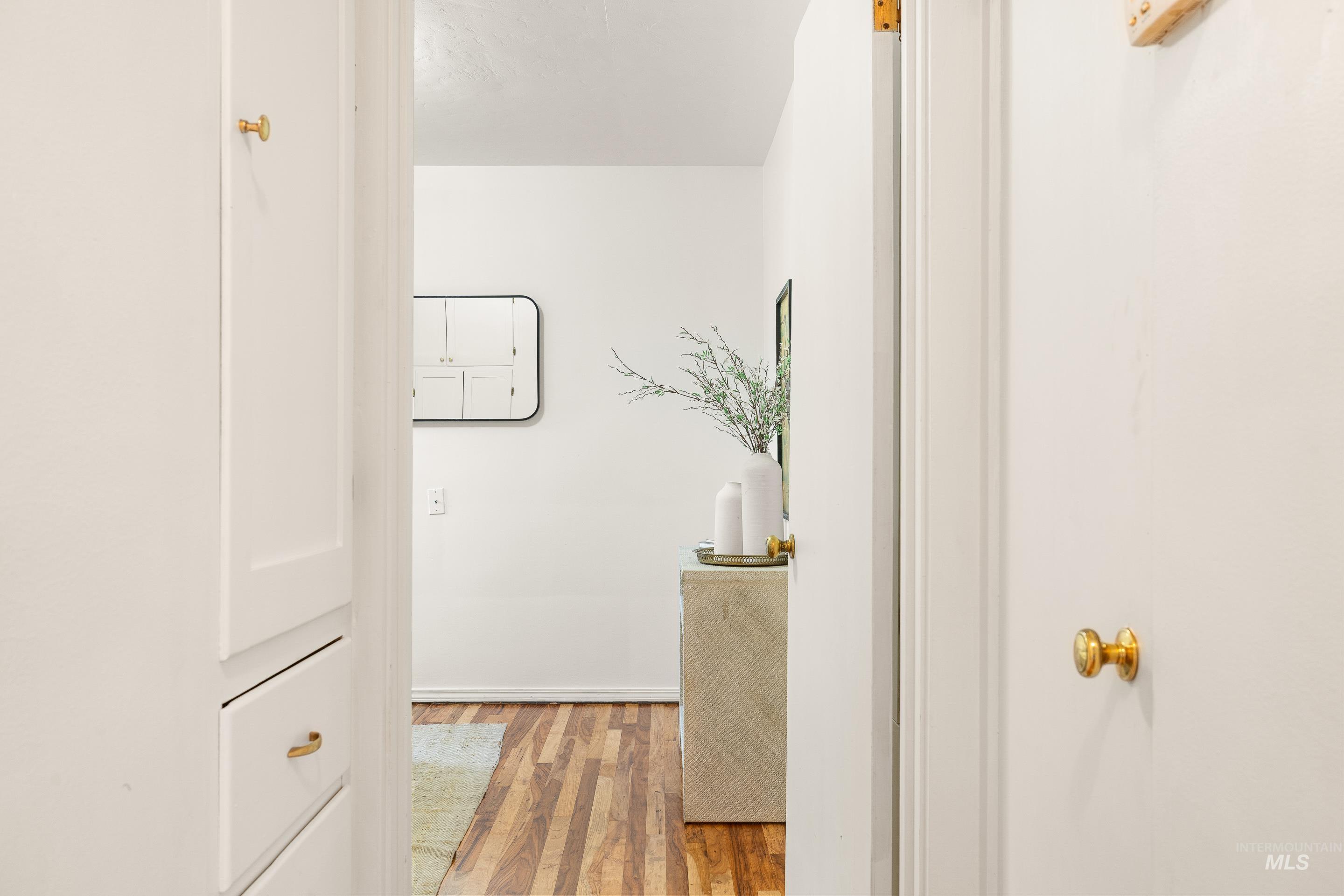 Hallway featuring light wood finished floors and baseboards