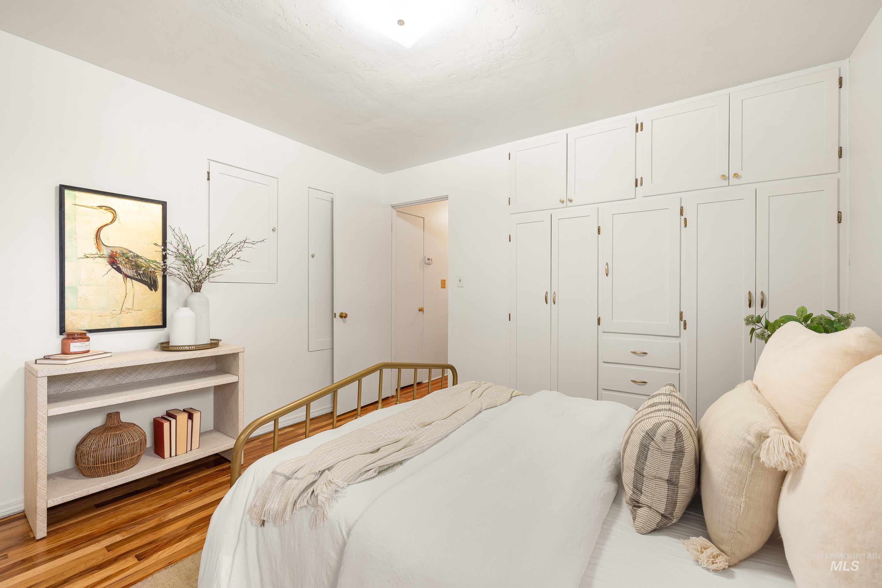 Bedroom featuring wood finished floors and a closet