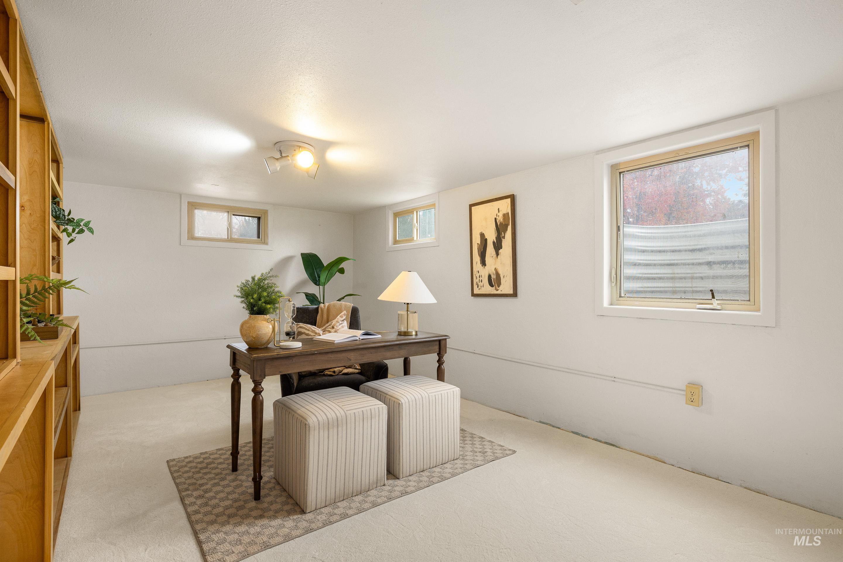 Home office with carpet floors and plenty of natural light