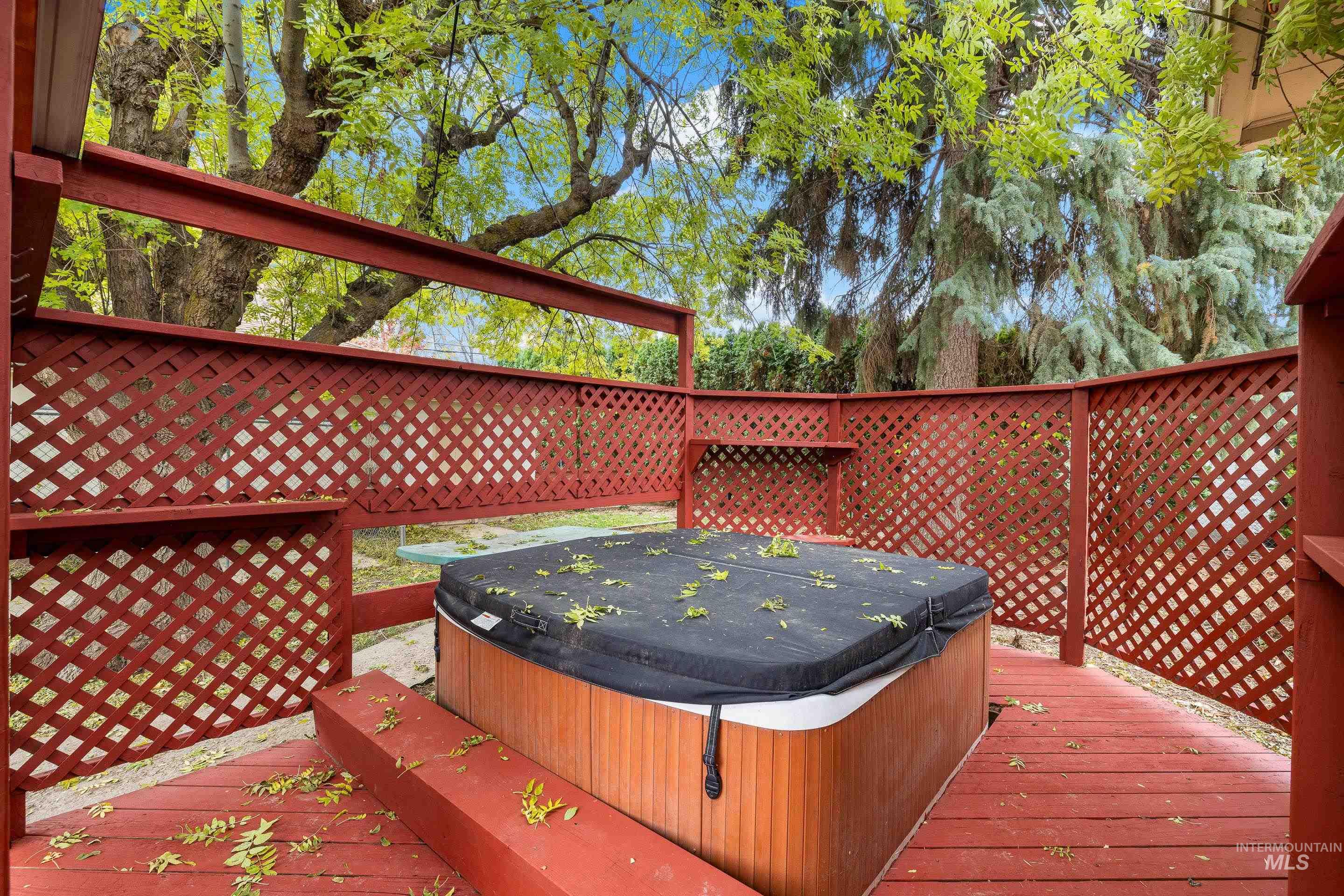 Wooden deck featuring a hot tub